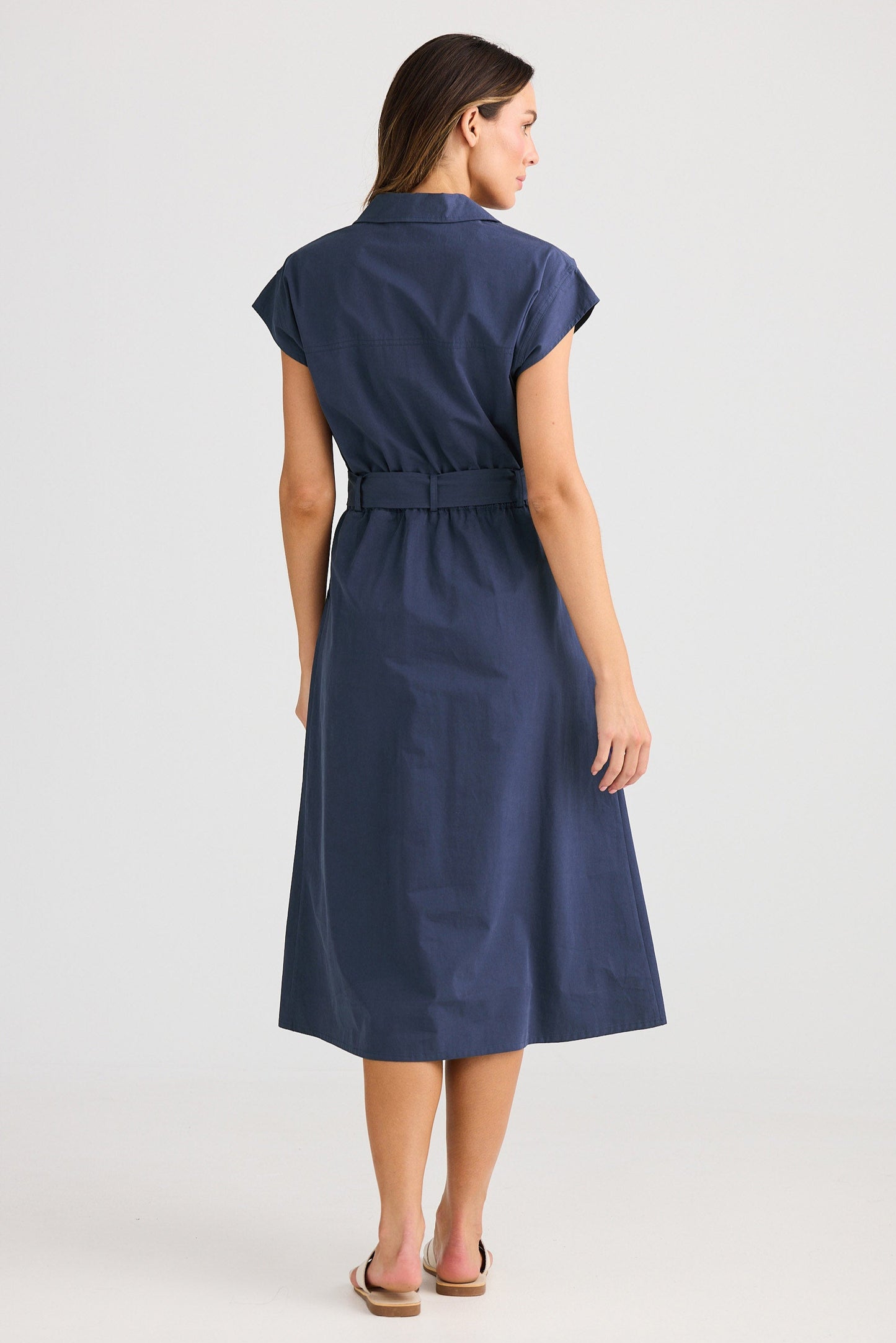 Woman wearing a navy blue dress on a white background