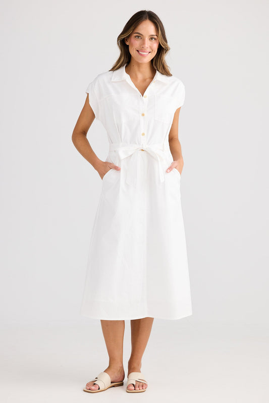 Woman wearing a white dress on a plain background