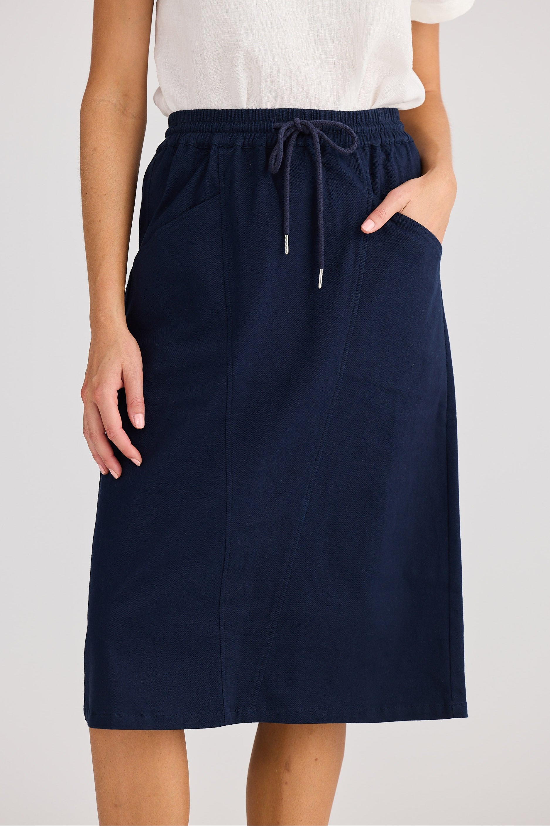 Navy blue skirt worn by a person on a white background