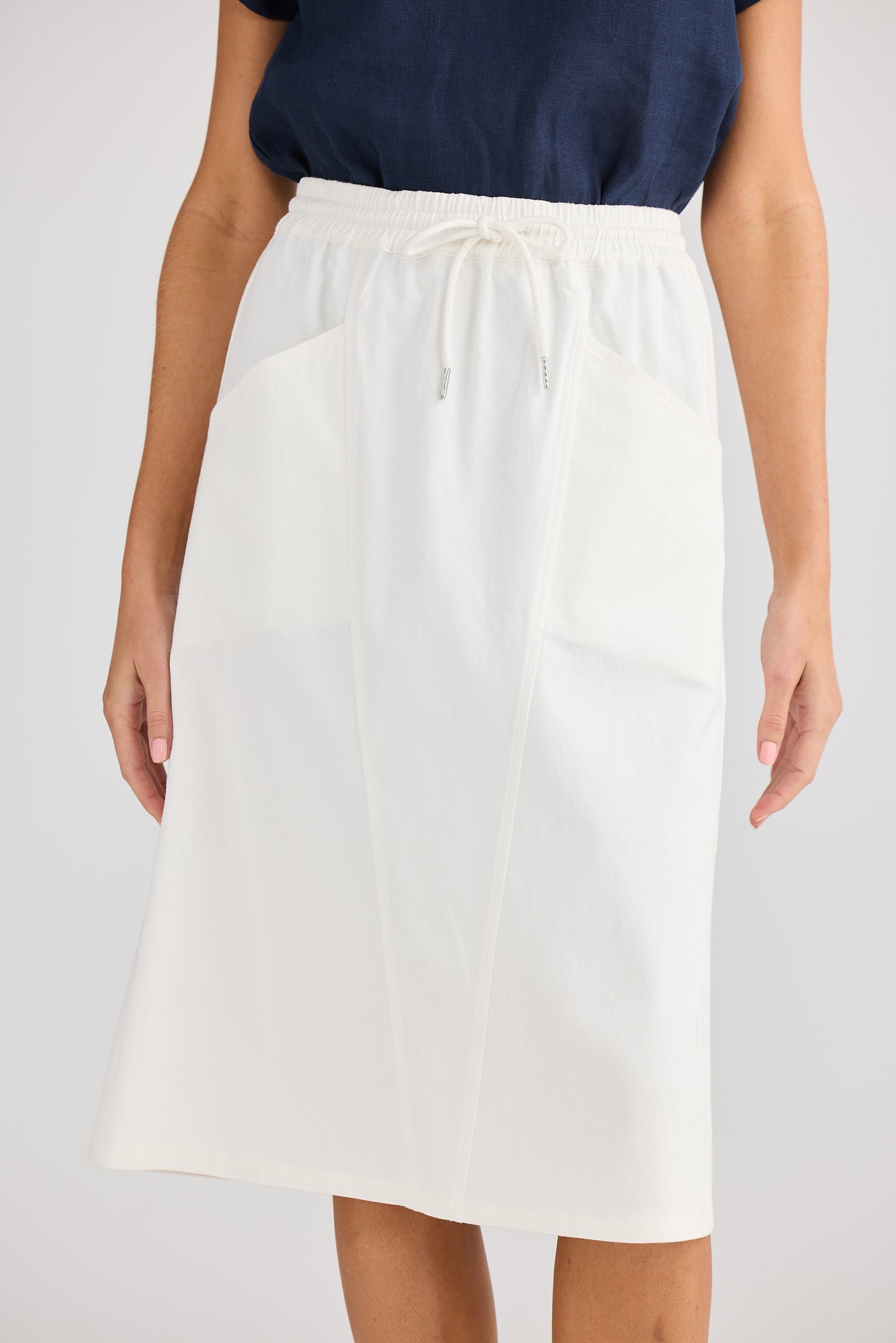 White skirt worn by a person on a white background