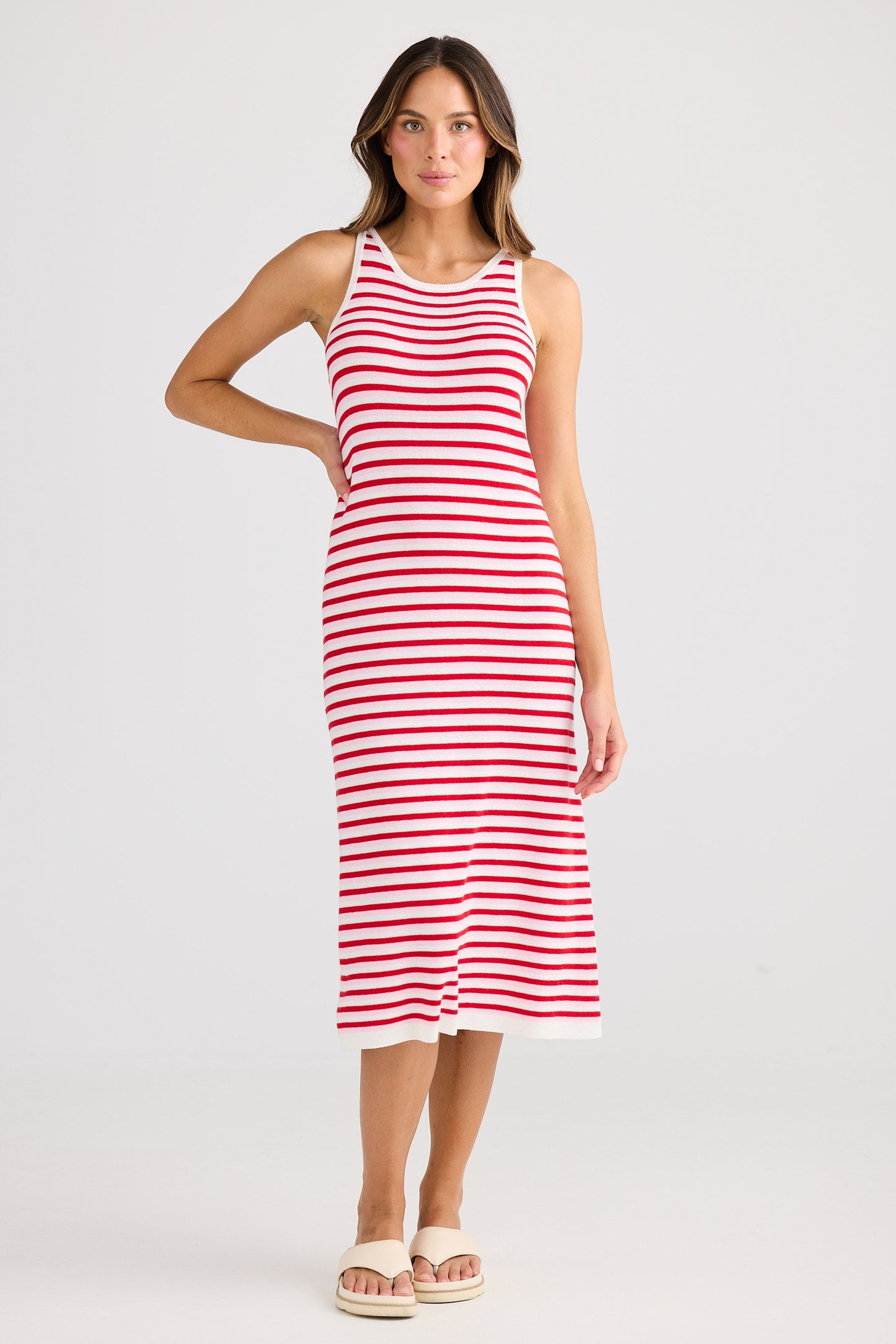 Woman wearing a red and white striped dress on a white background