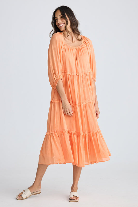 Woman wearing an orange dress on a white background