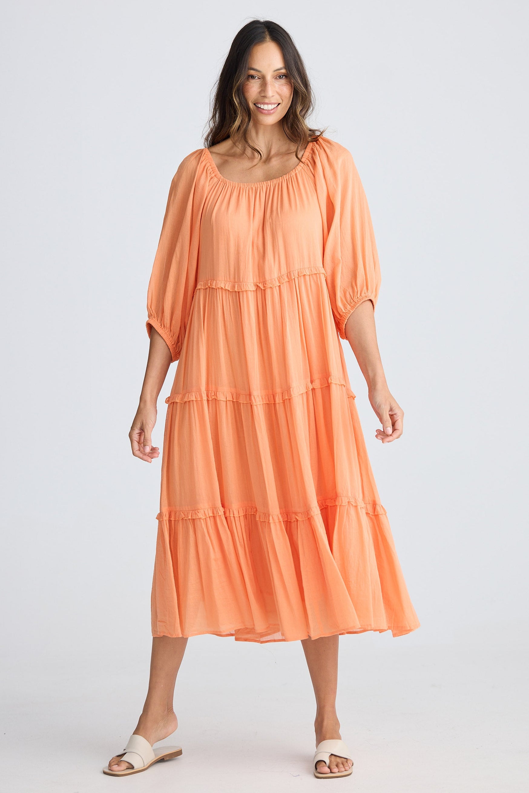 Woman wearing an orange dress on a white background