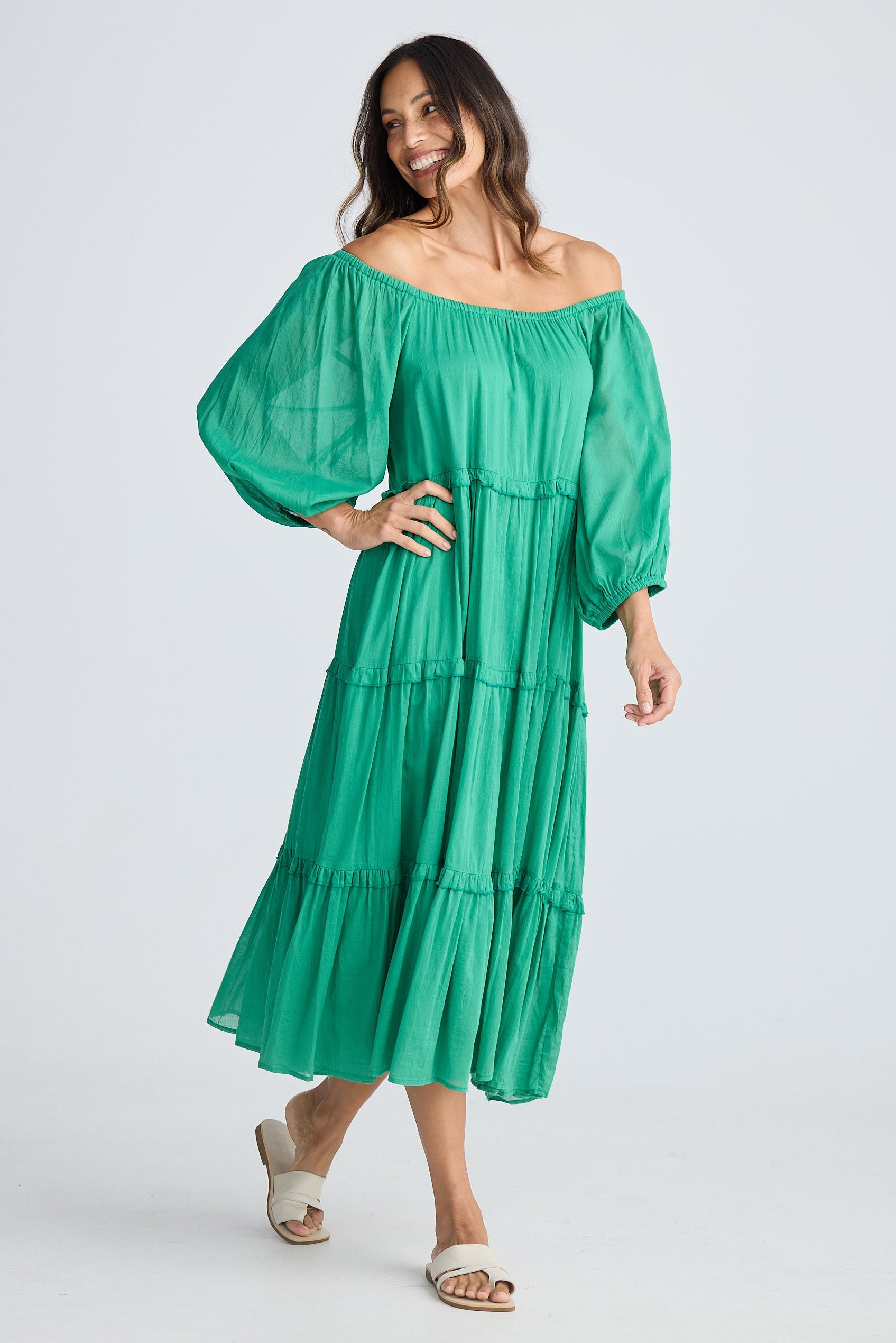 Woman wearing a green dress on a white background