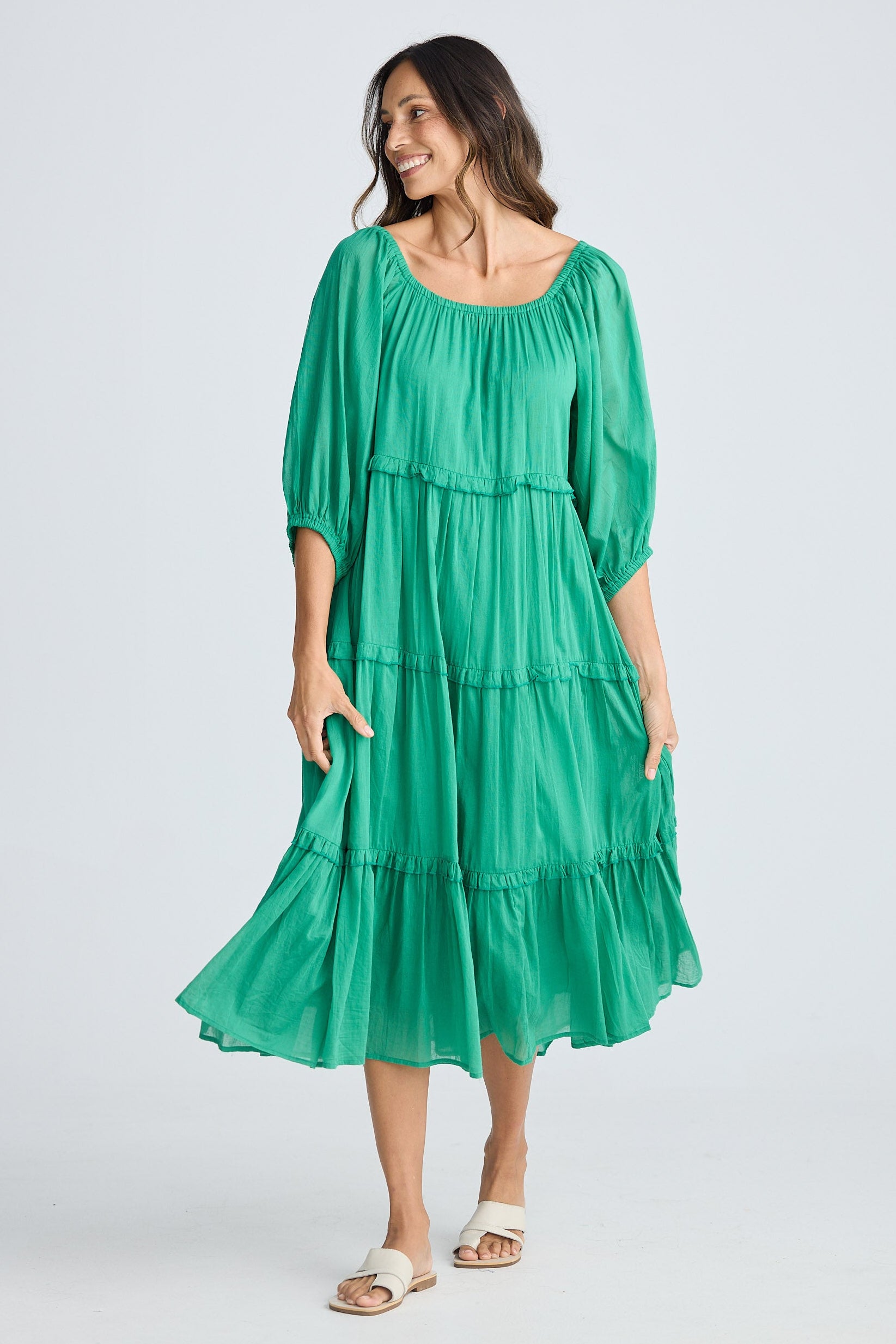 Woman wearing a green dress on a white background