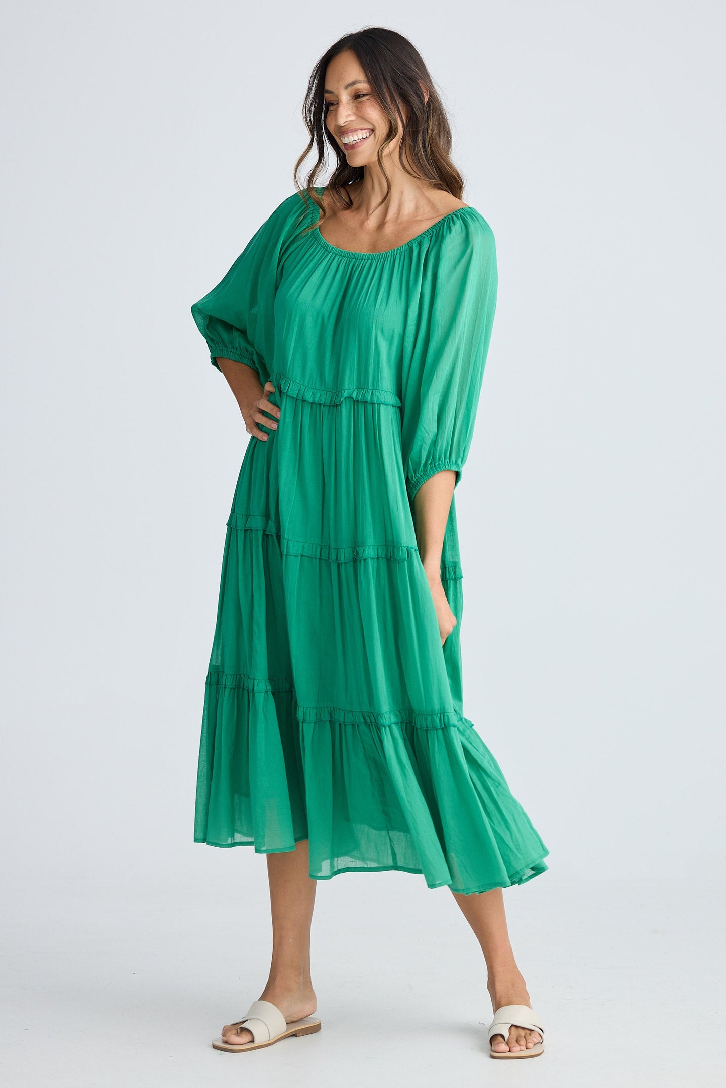 Woman wearing a green dress on a white background