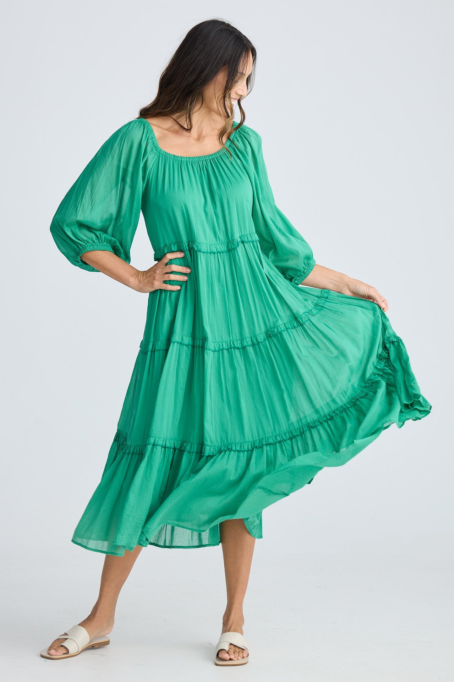 Woman wearing a green dress on a white background