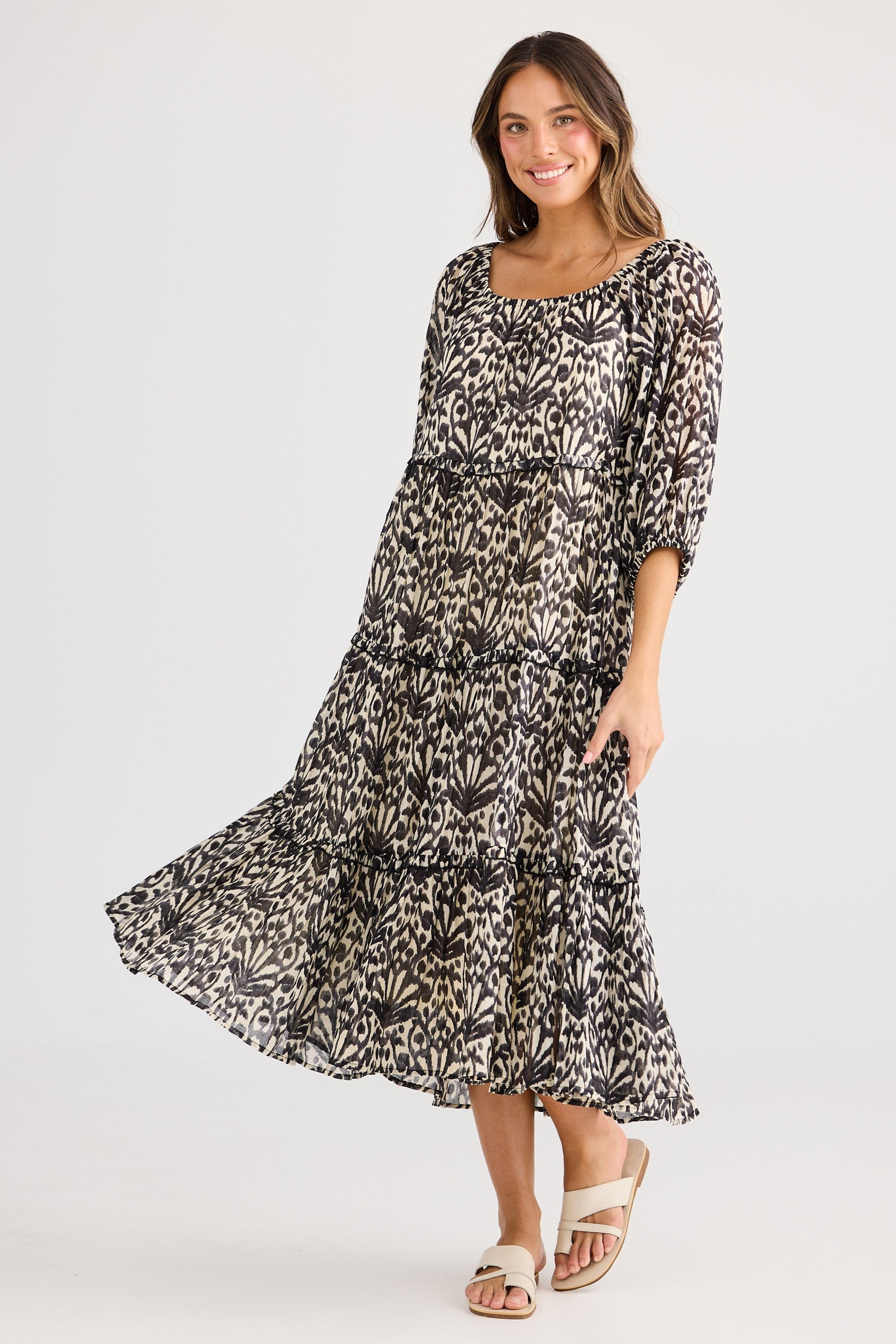 Woman wearing a patterned dress on a white background