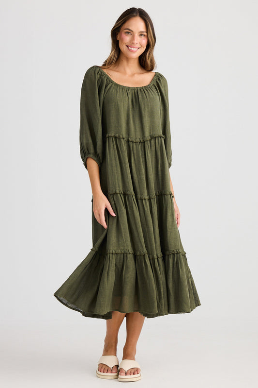 Woman wearing a green dress on a white background