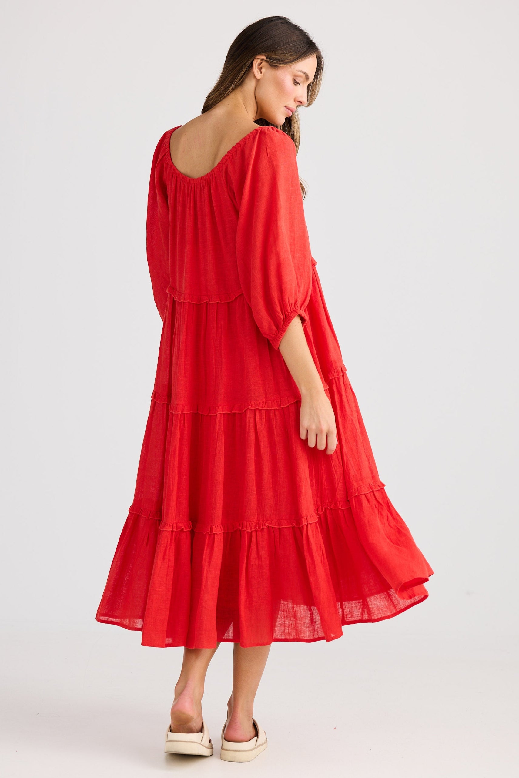 Woman wearing a red dress on a white background
