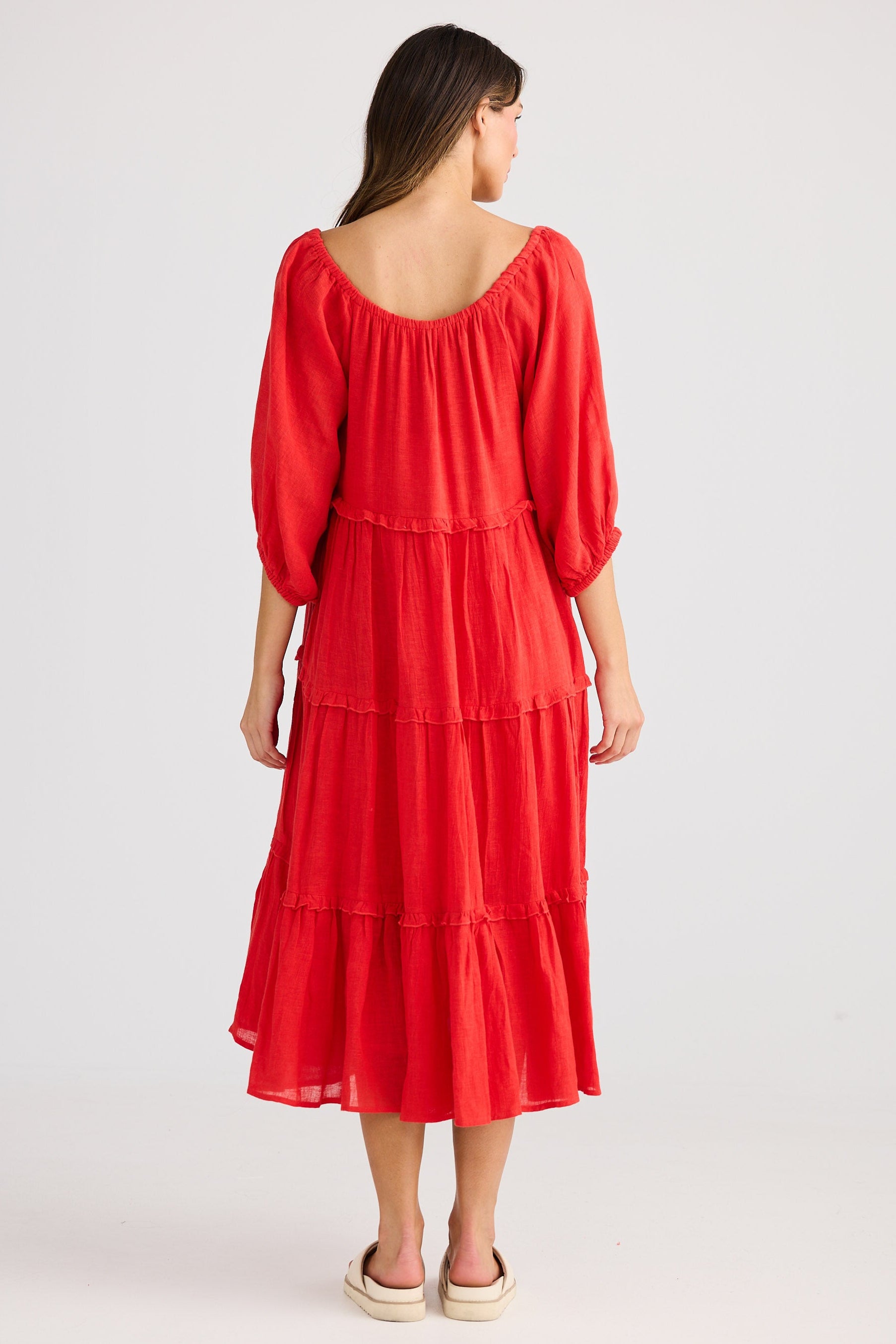 Woman wearing a red dress on a white background