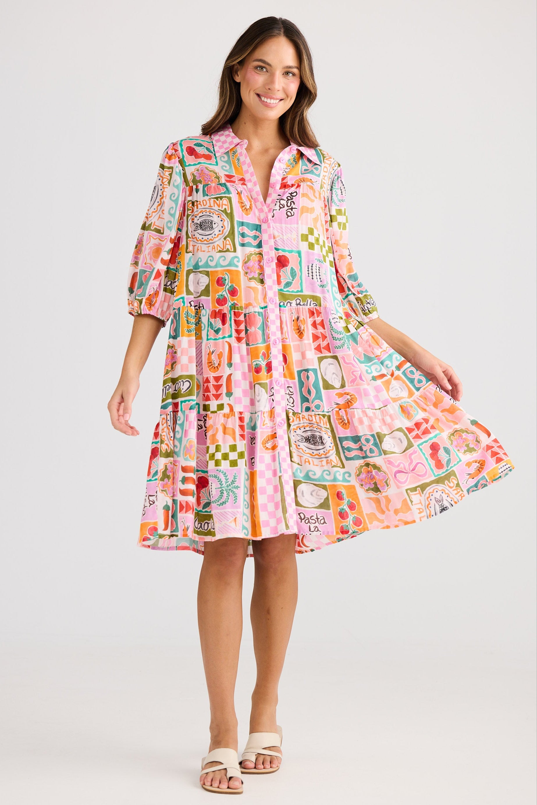 Woman wearing a colorful patterned dress on a white background