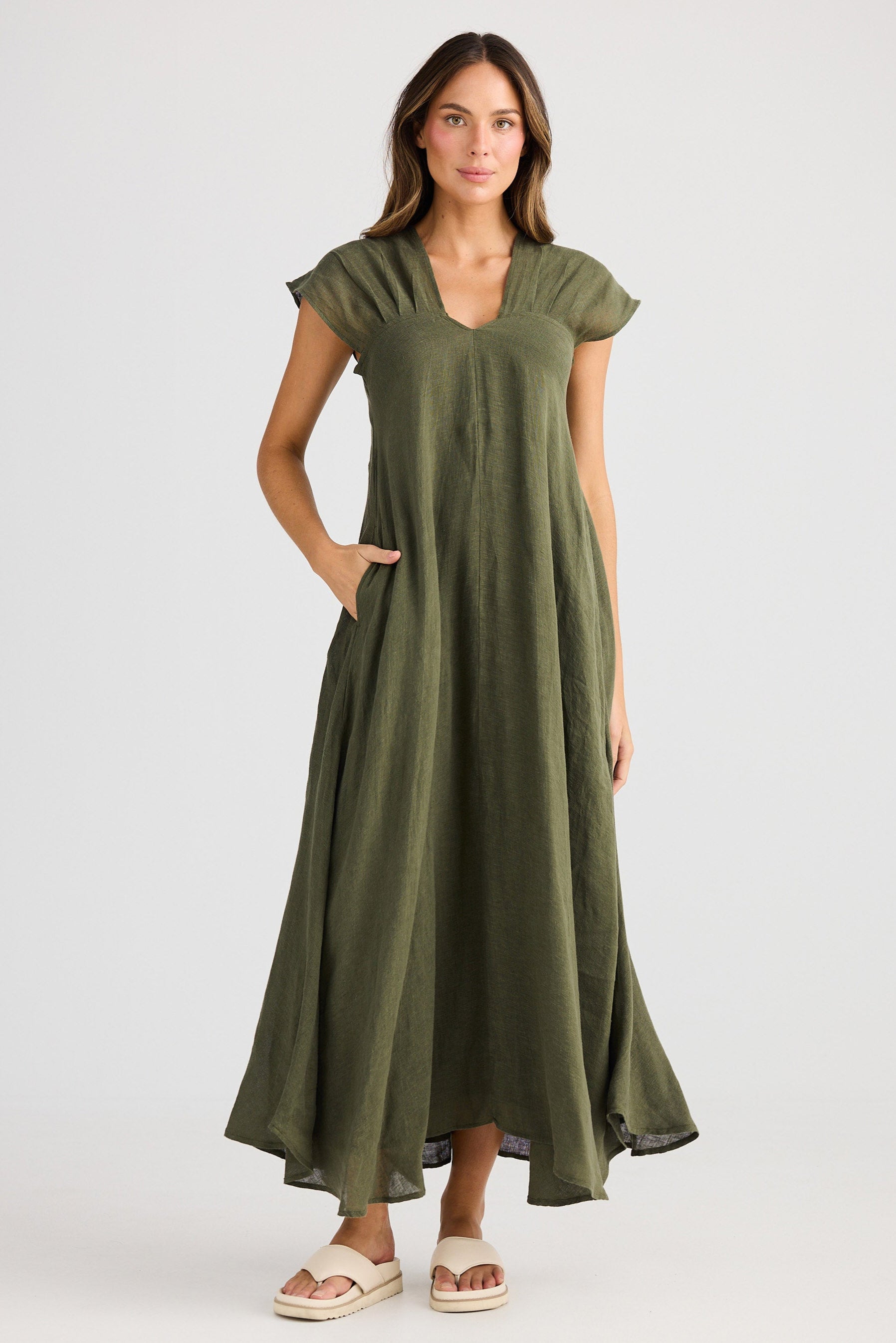 Woman wearing a green dress on a white background