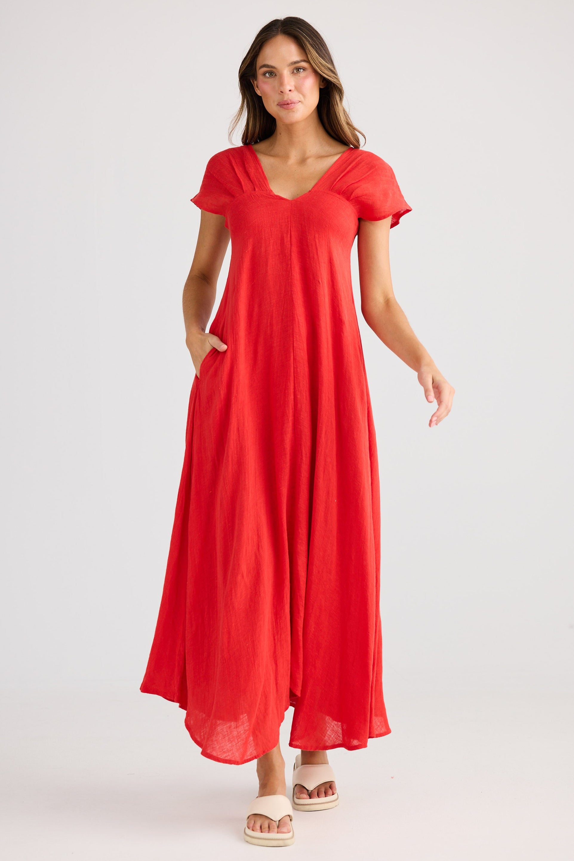 Woman wearing a red dress on a white background