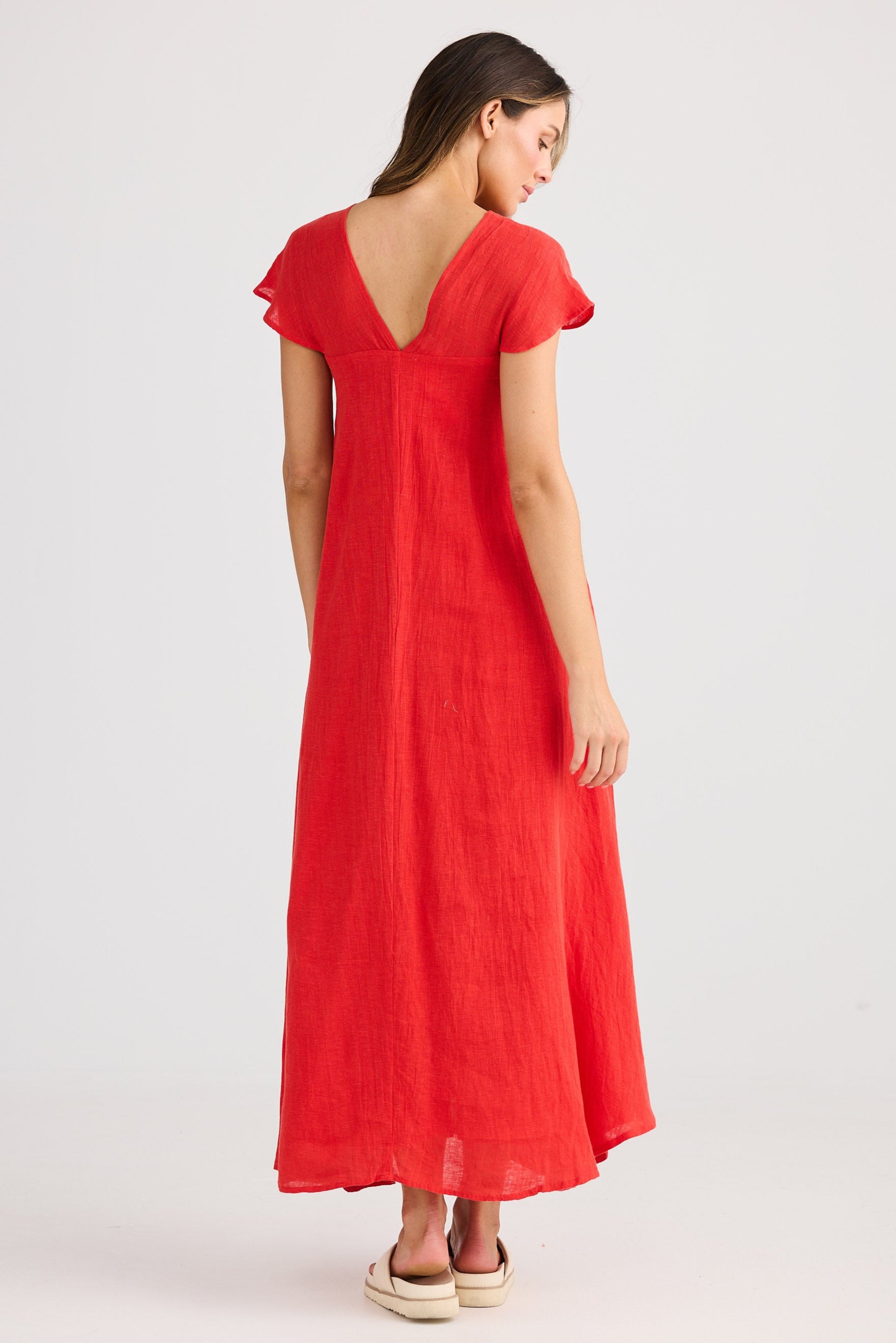 Woman wearing a red dress on a white background