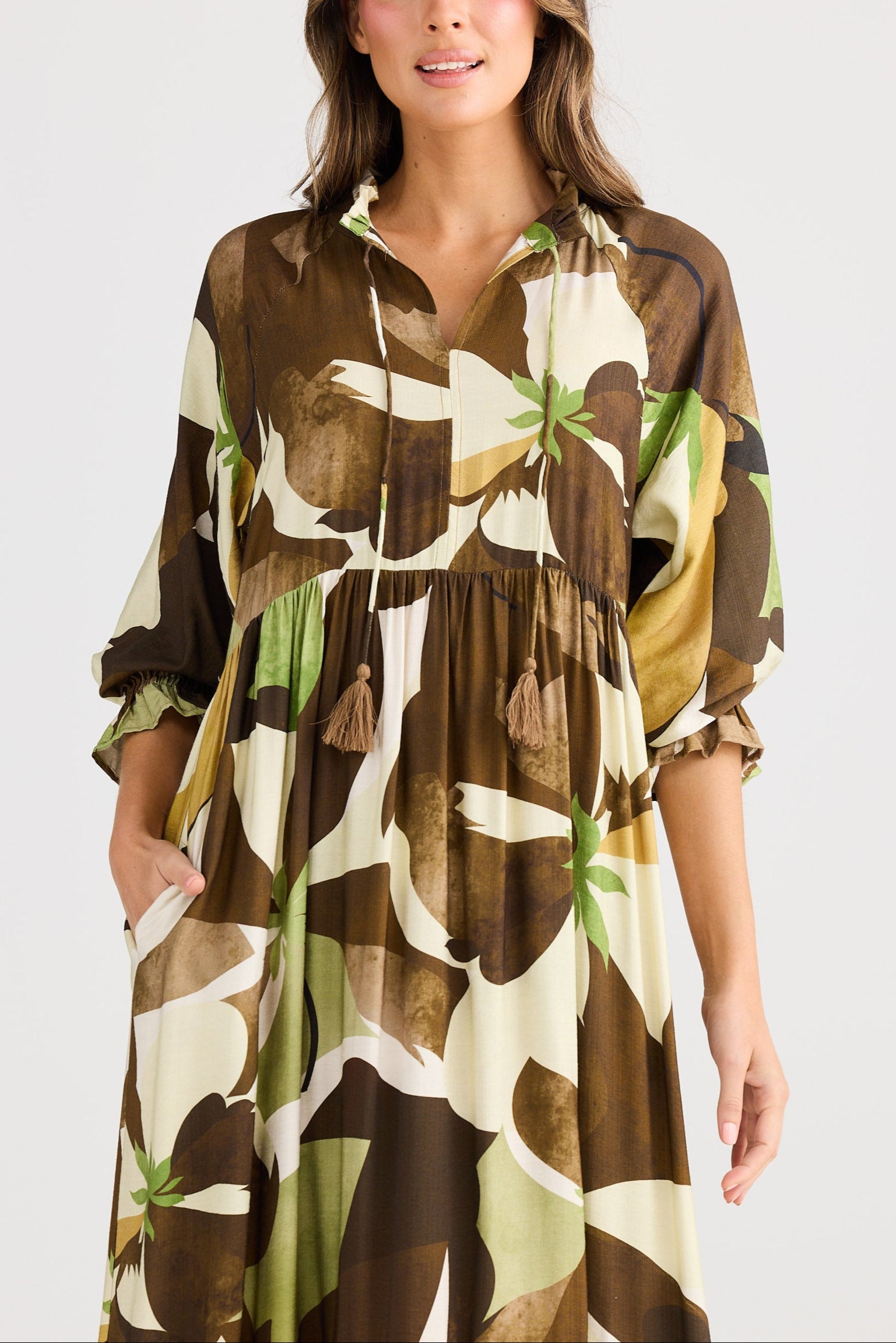 Woman wearing a patterned dress on a white background