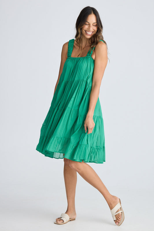 Woman wearing a green dress on a white background