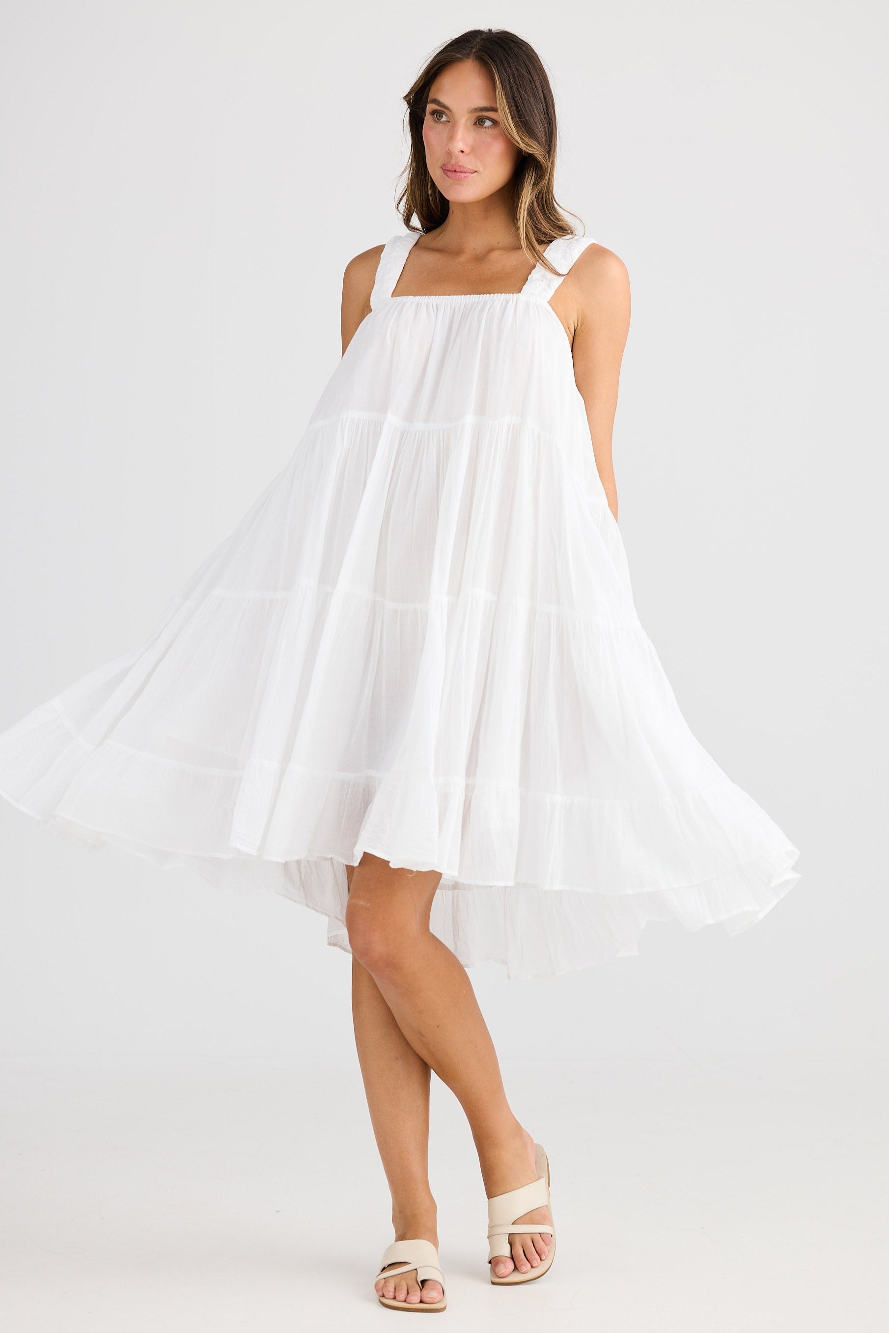 Woman wearing a white dress on a white background