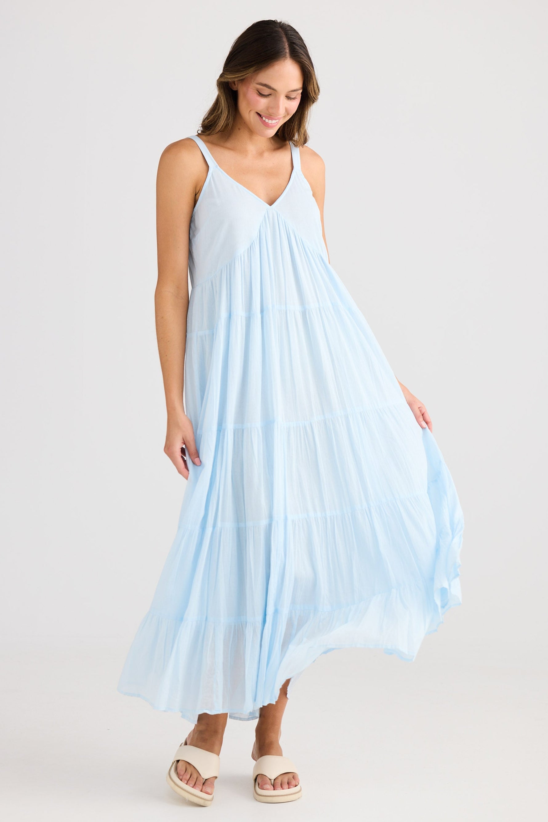 Woman wearing a light blue dress on a white background