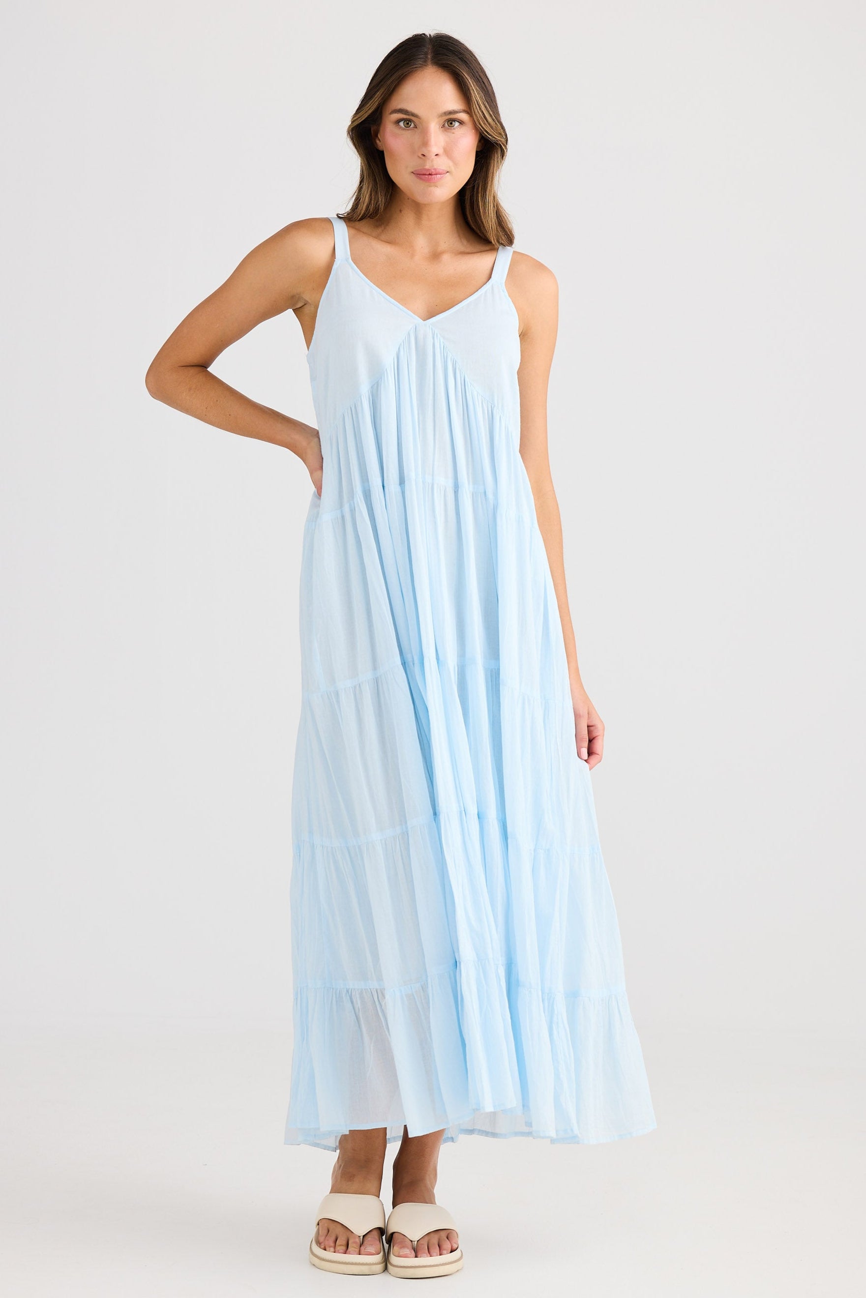 Woman wearing a light blue dress on a white background