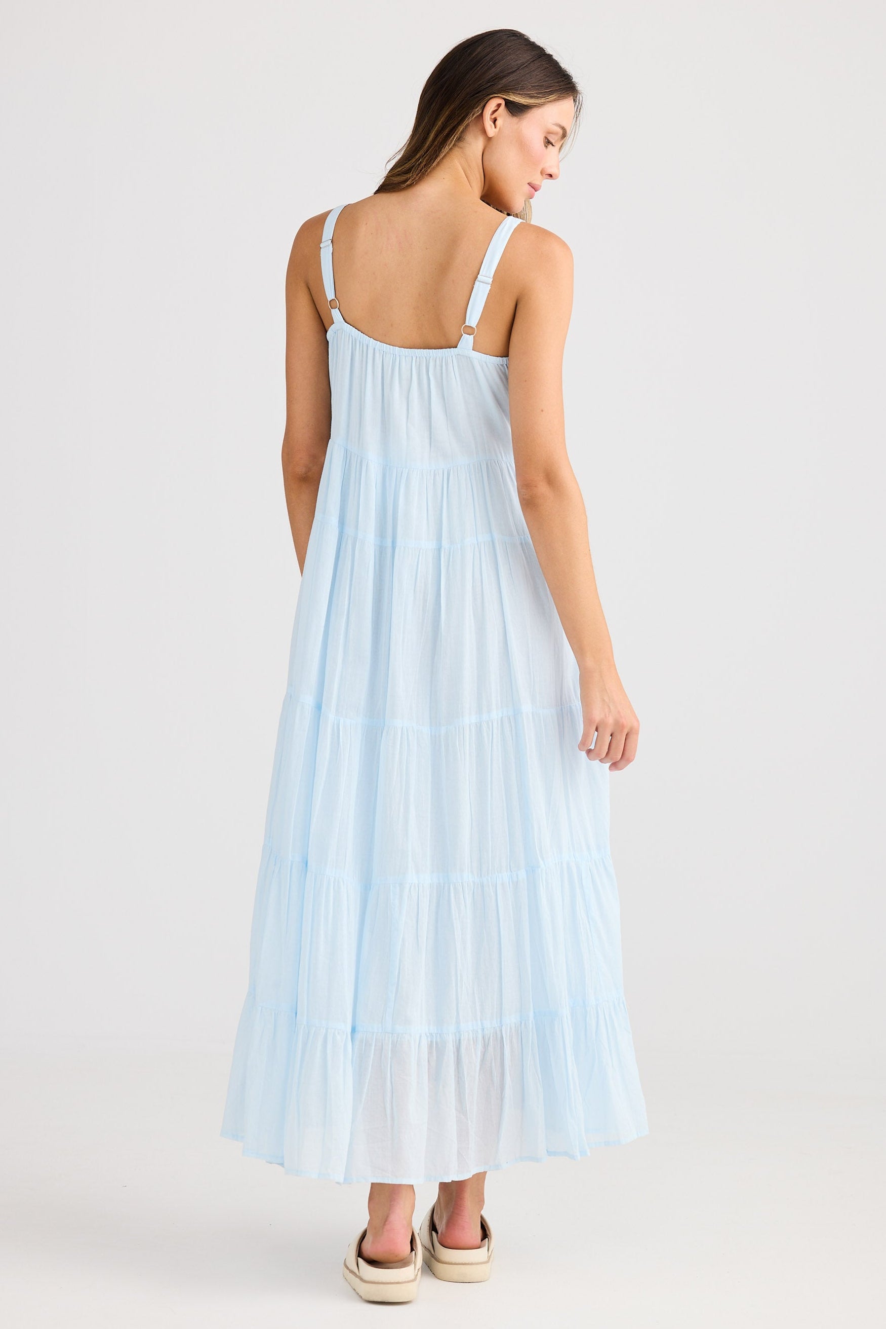 Woman wearing a light blue dress on a white background