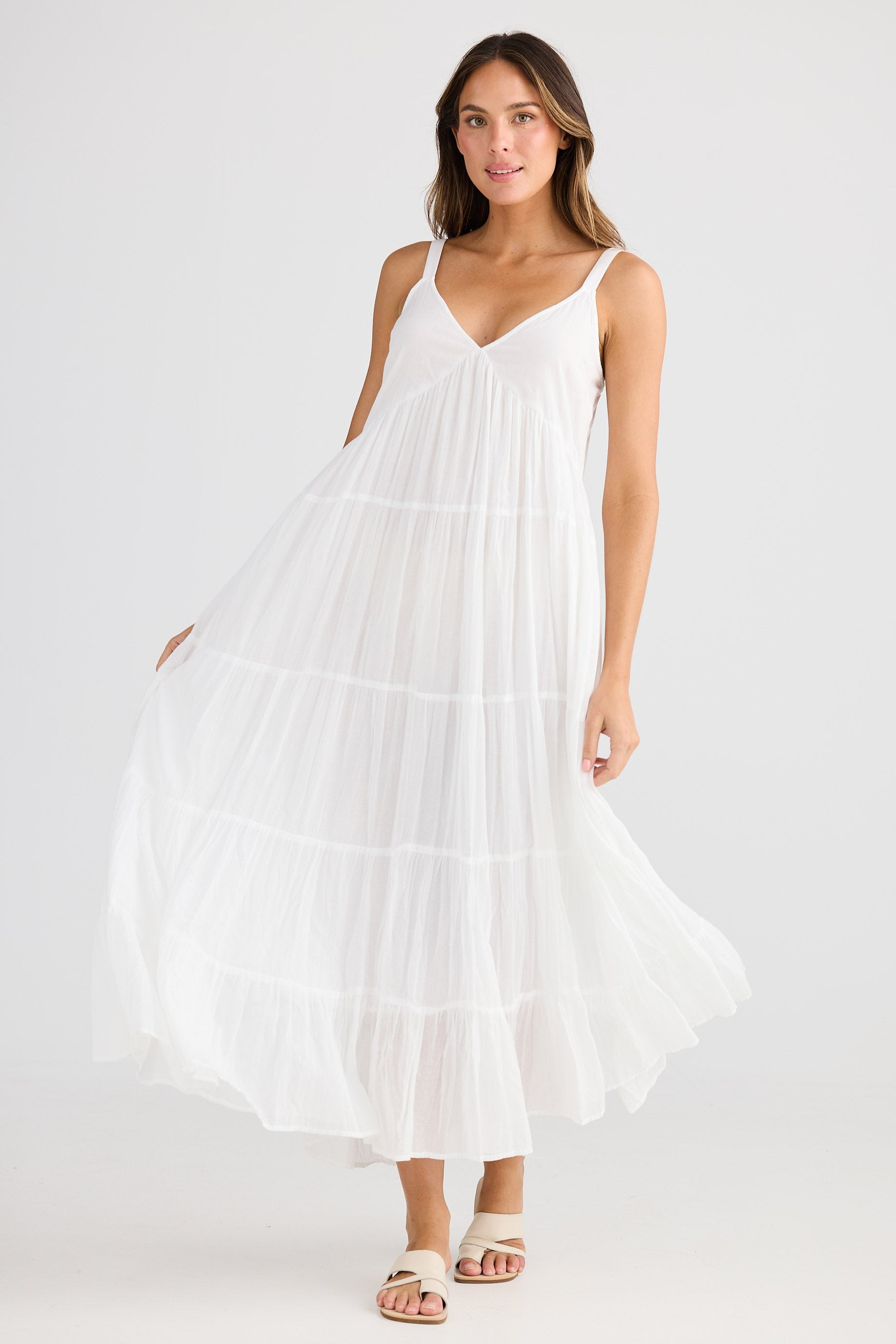 Woman wearing a white dress on a white background