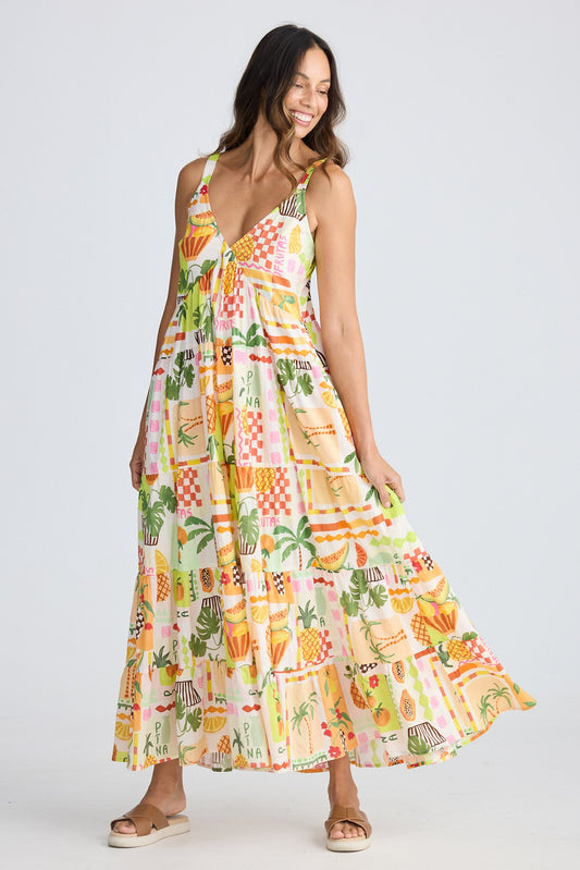 Woman wearing a colorful patterned dress on a white background