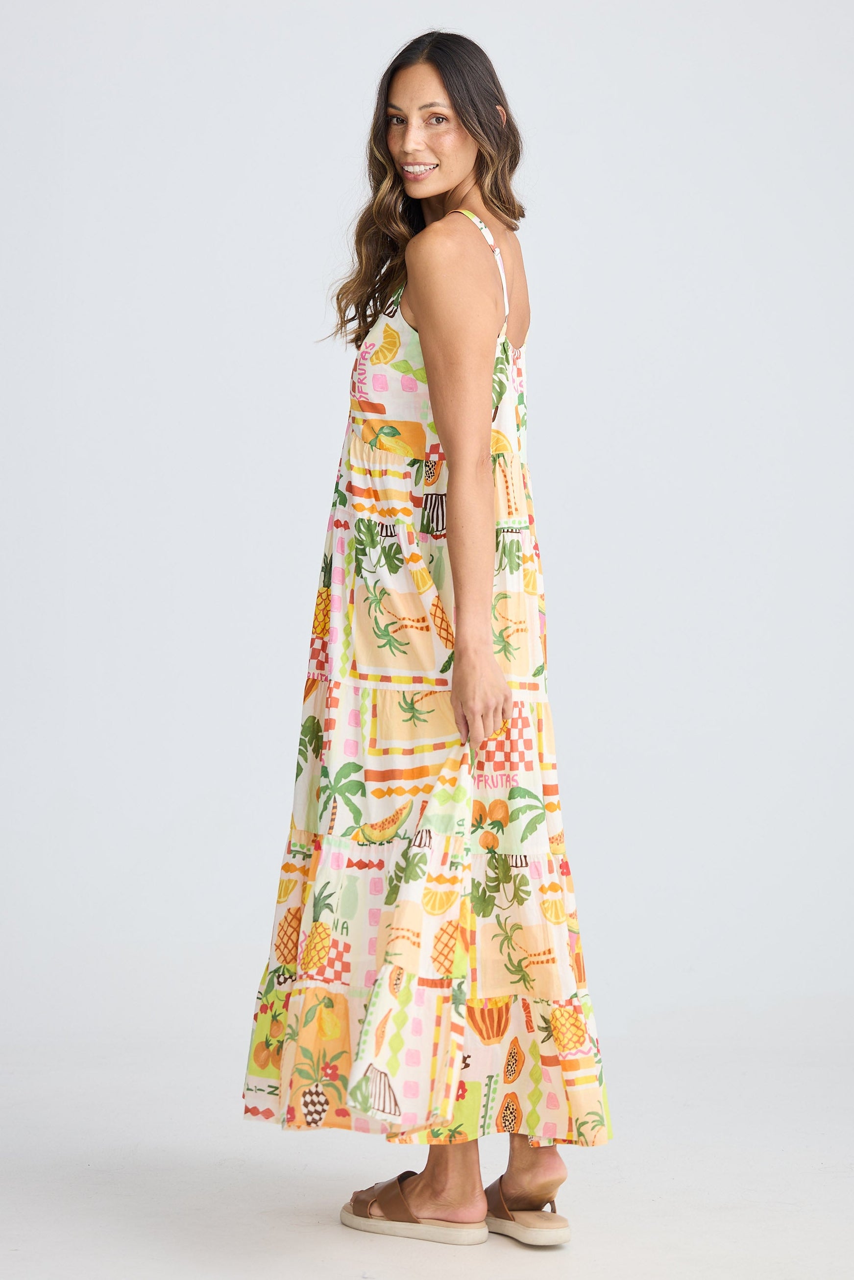 Woman wearing a colorful floral dress on a white background
