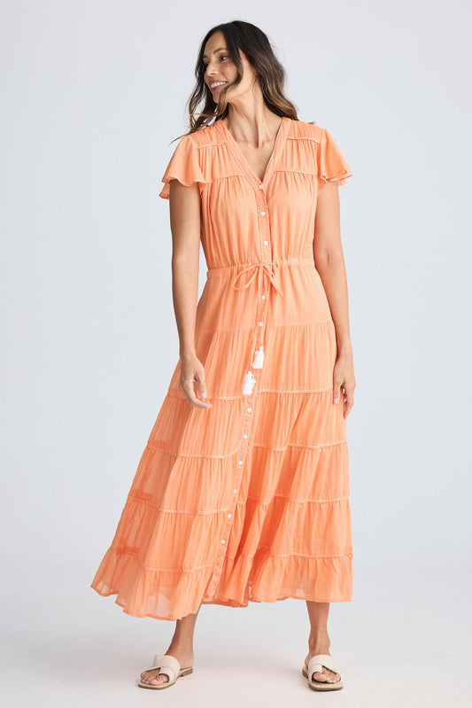 Woman wearing an orange dress on a white background