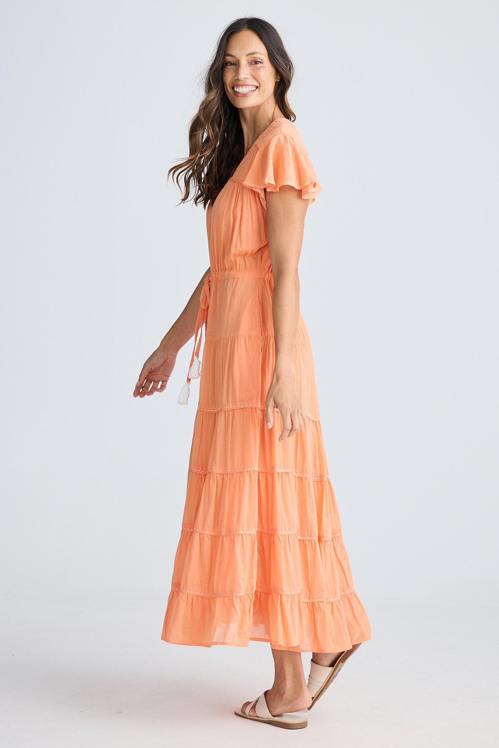Woman wearing an orange dress on a white background