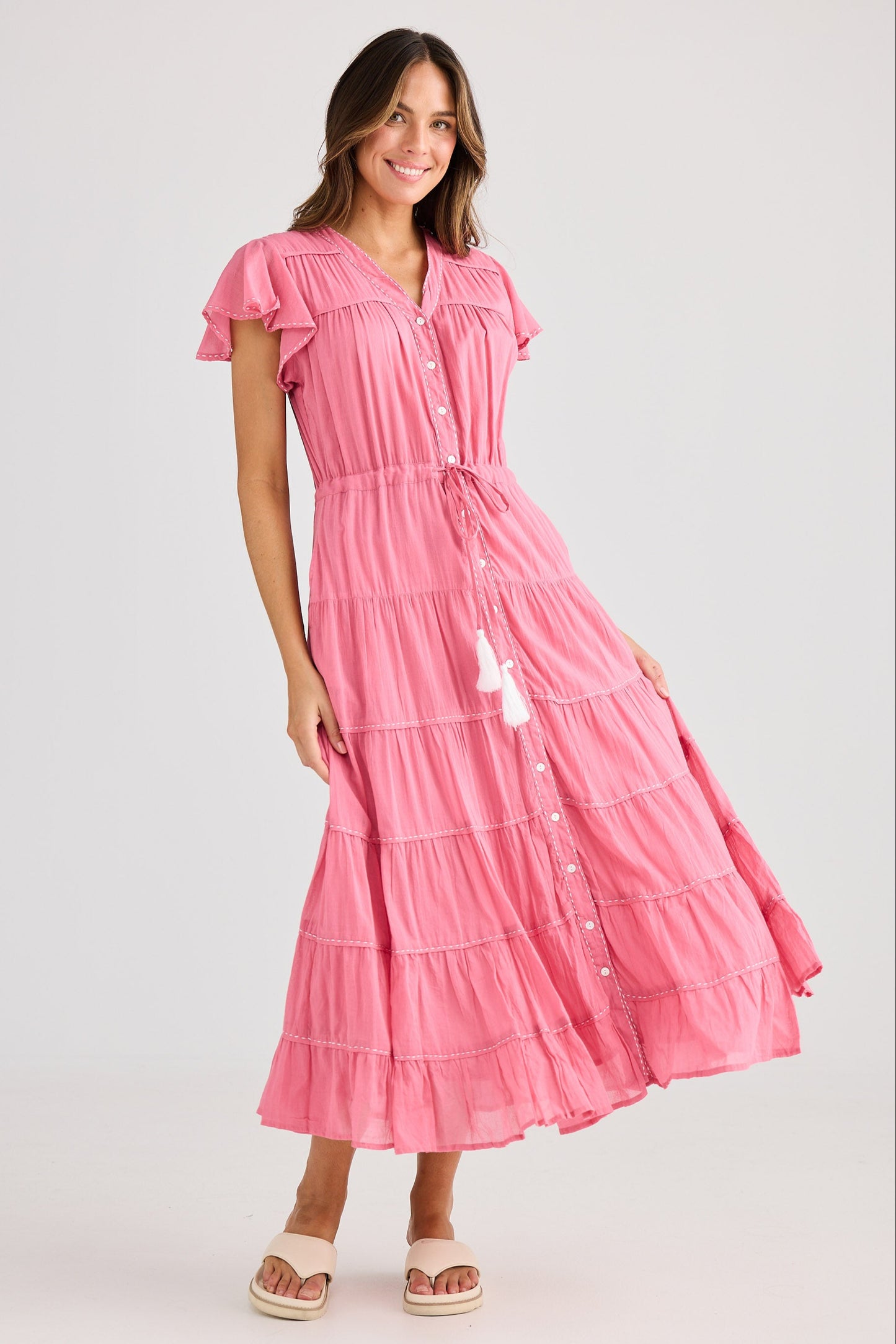 Woman wearing a pink dress on a white background