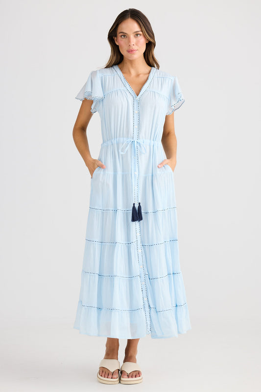 Woman wearing a light blue dress with a white background