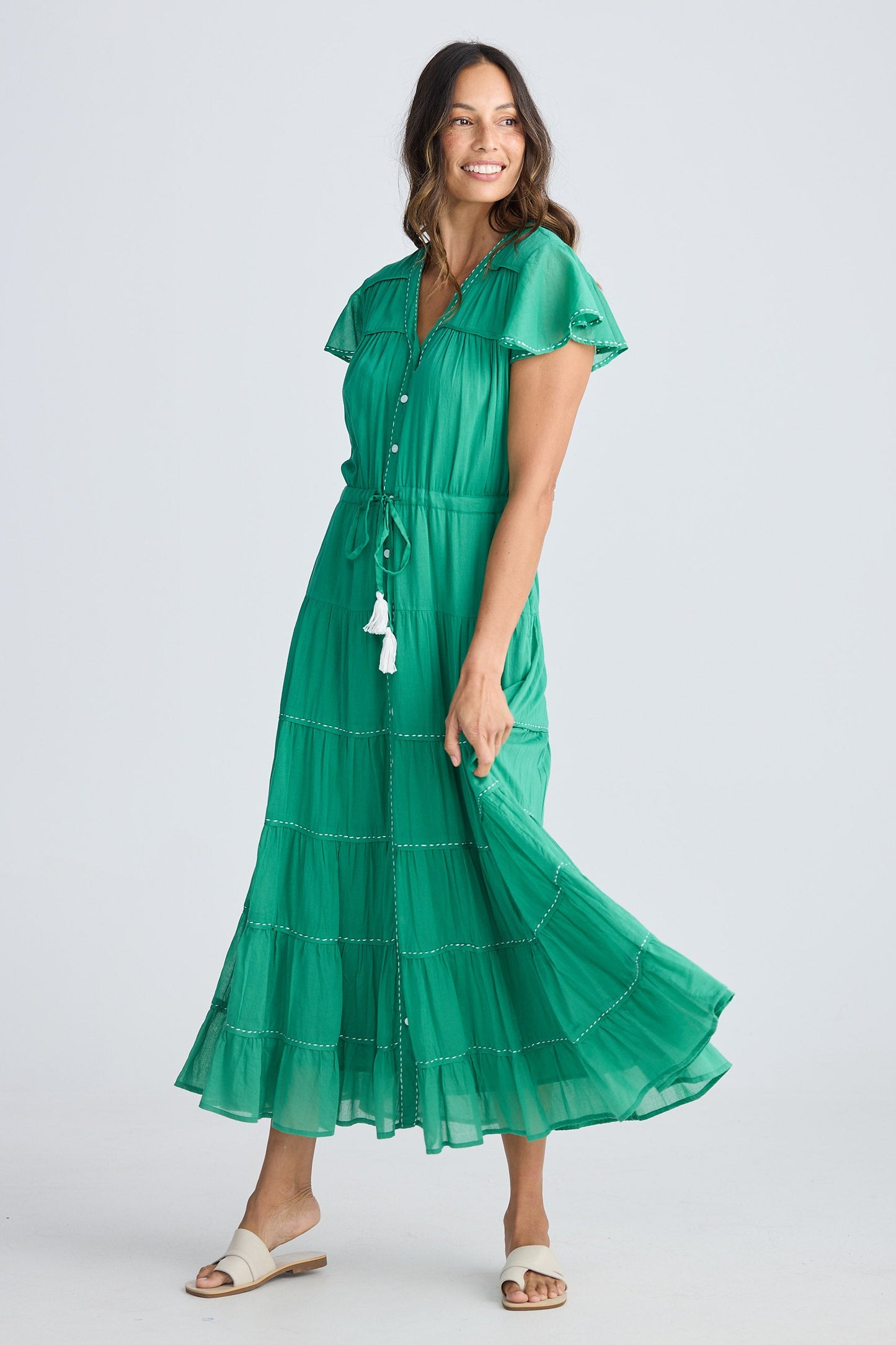 Woman wearing a green dress on a white background