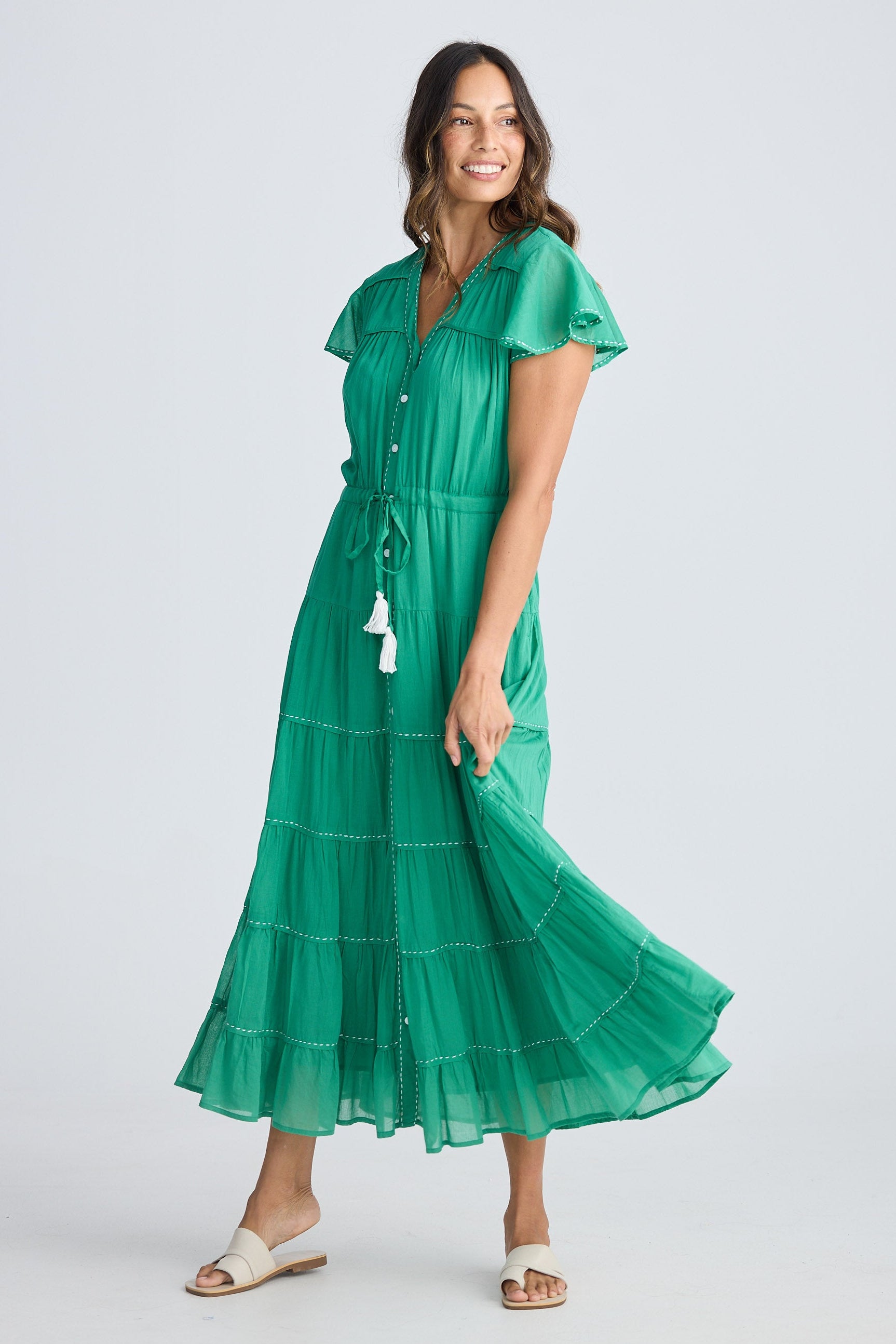 Woman wearing a green dress on a white background