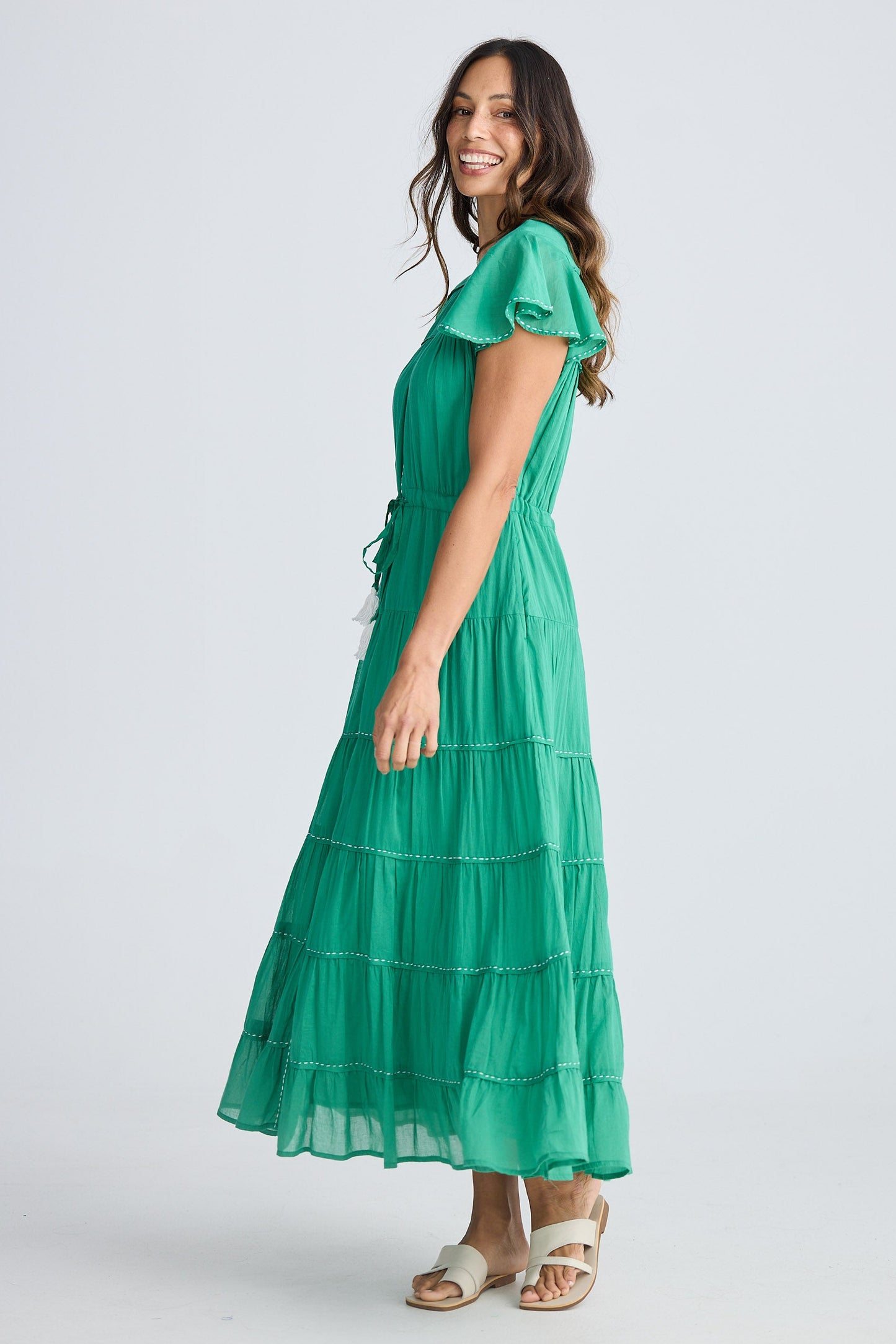 Woman wearing a green dress on a white background