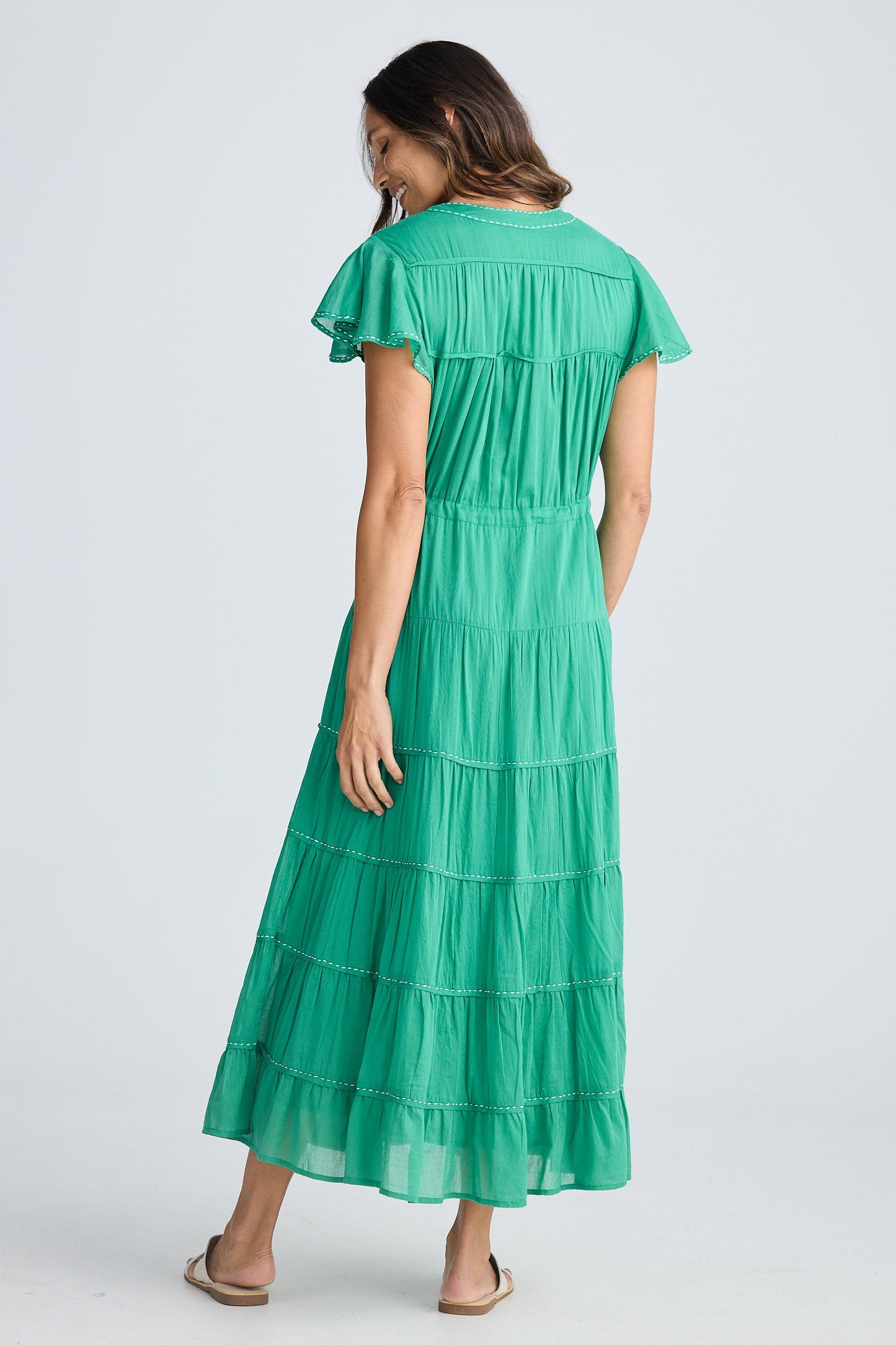 Woman wearing a green dress on a white background