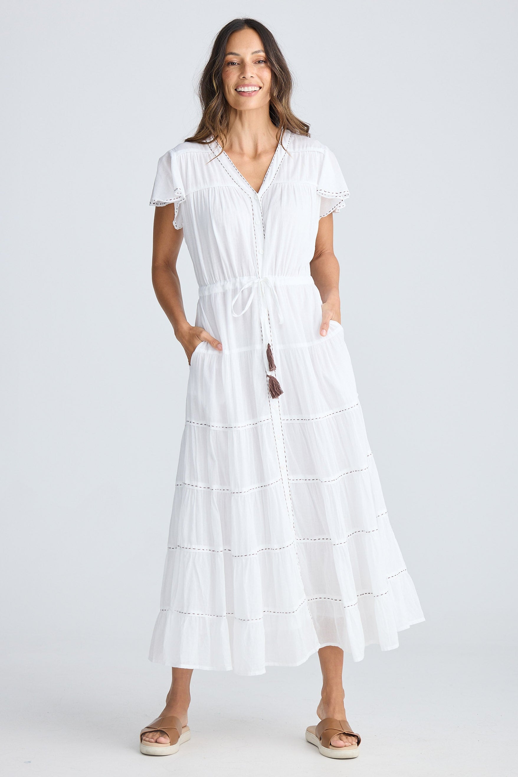 Woman wearing a white dress on a white background