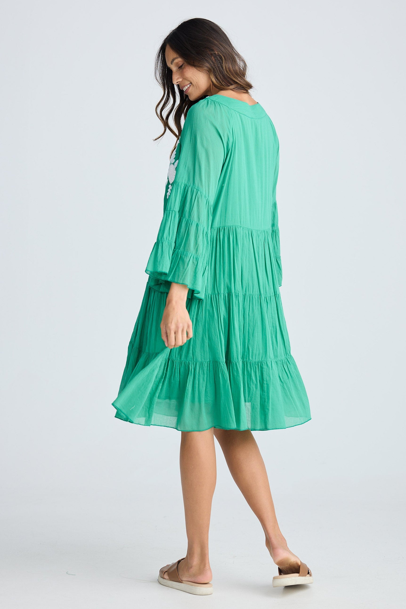 Woman wearing a green dress with a white background