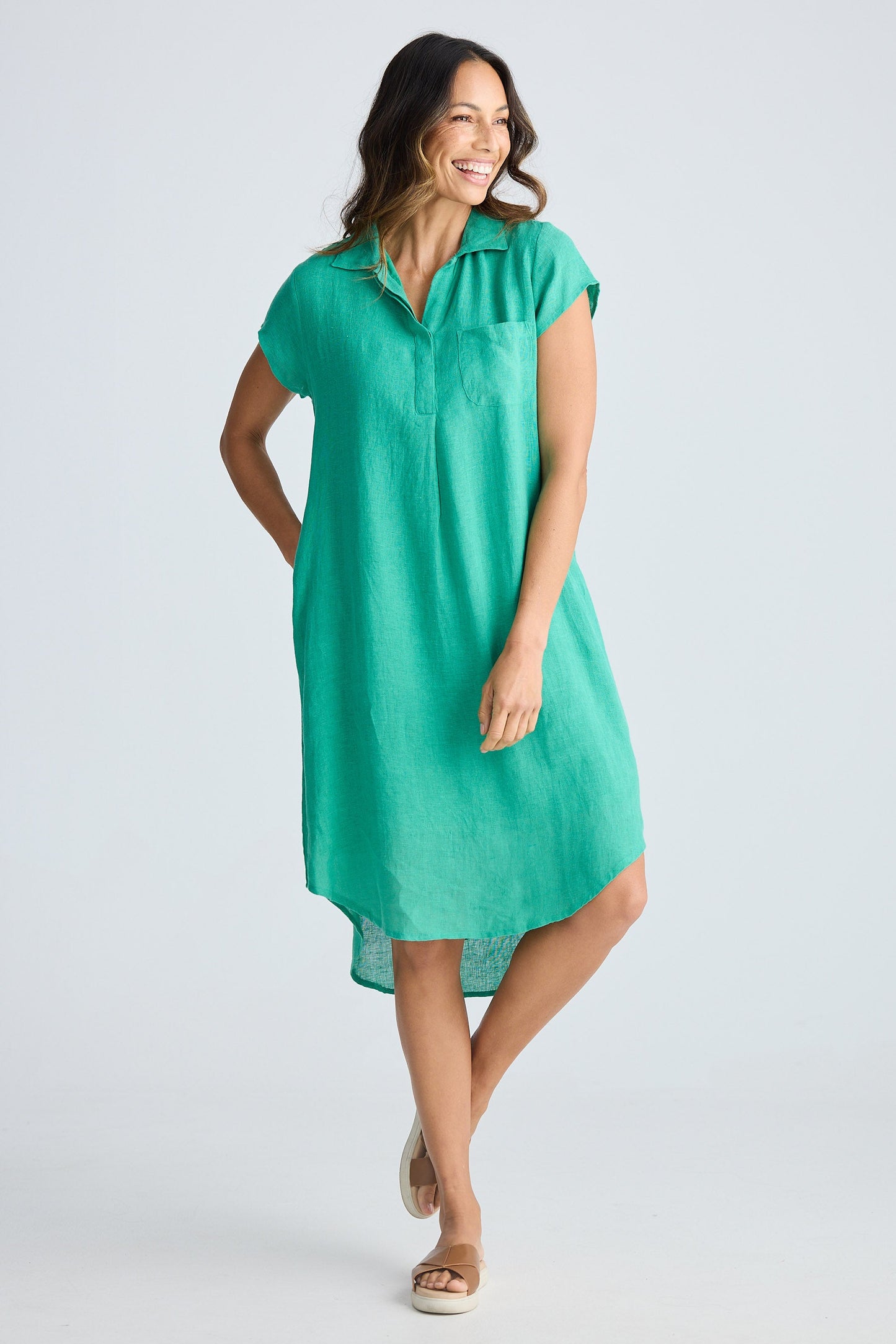 Woman wearing a green dress on a white background