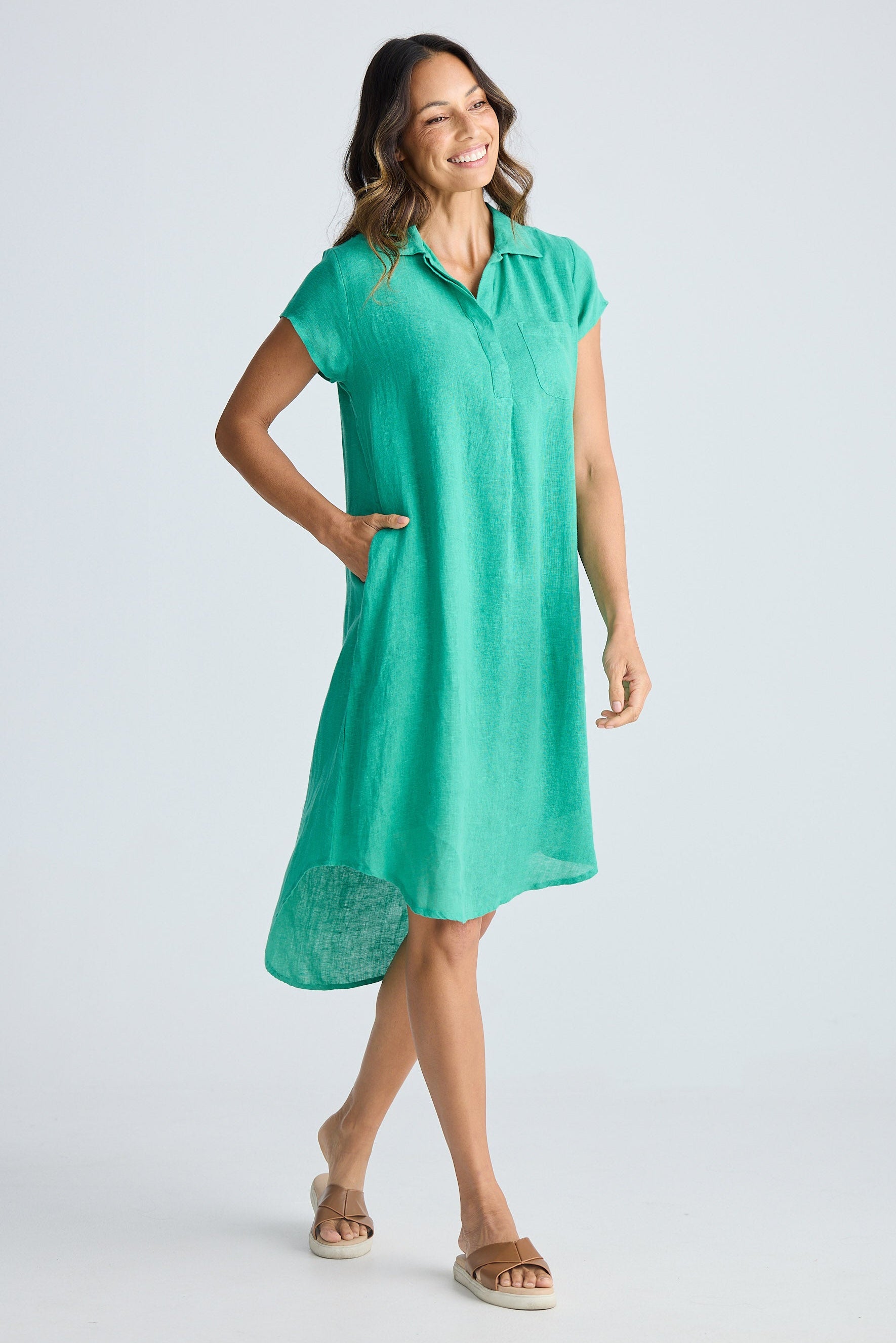 Woman wearing a green dress on a white background