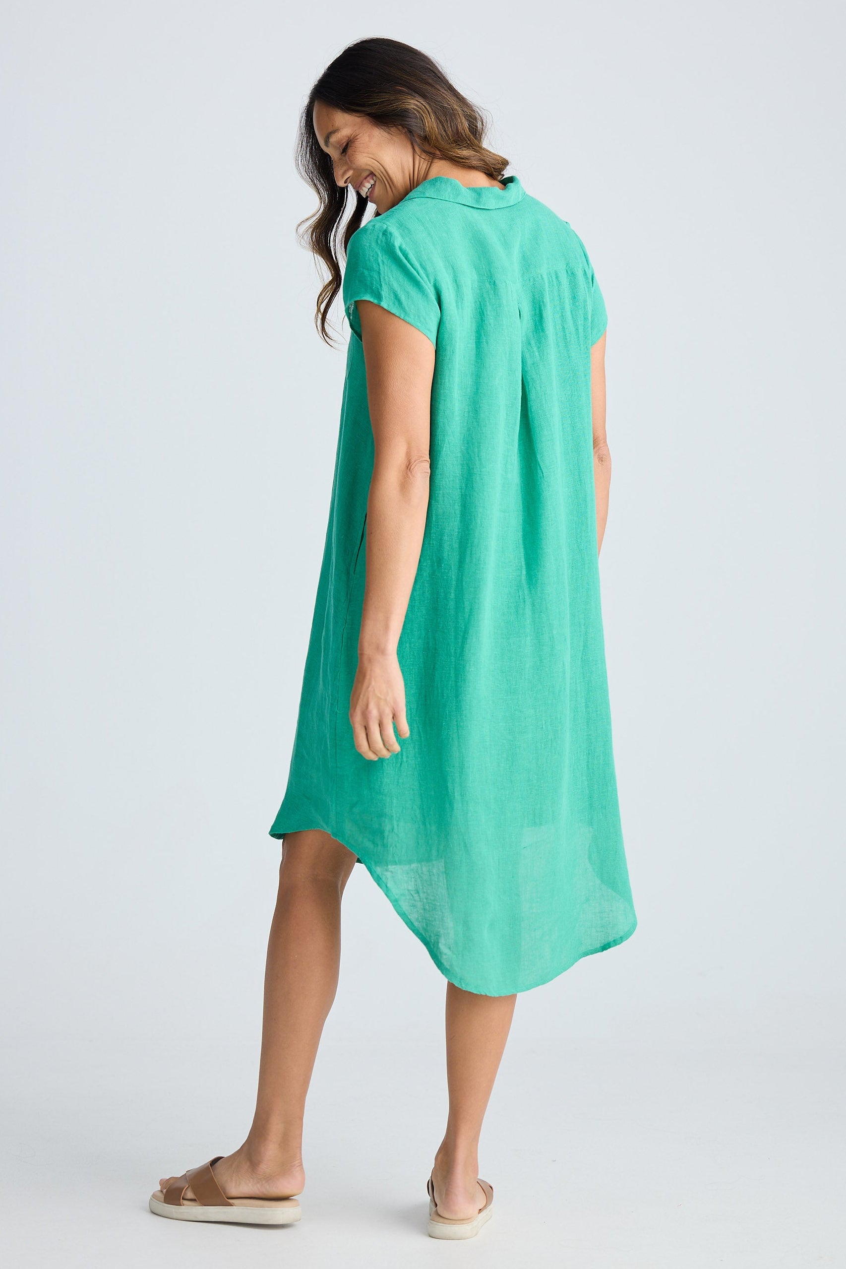 Woman wearing a green dress on a white background