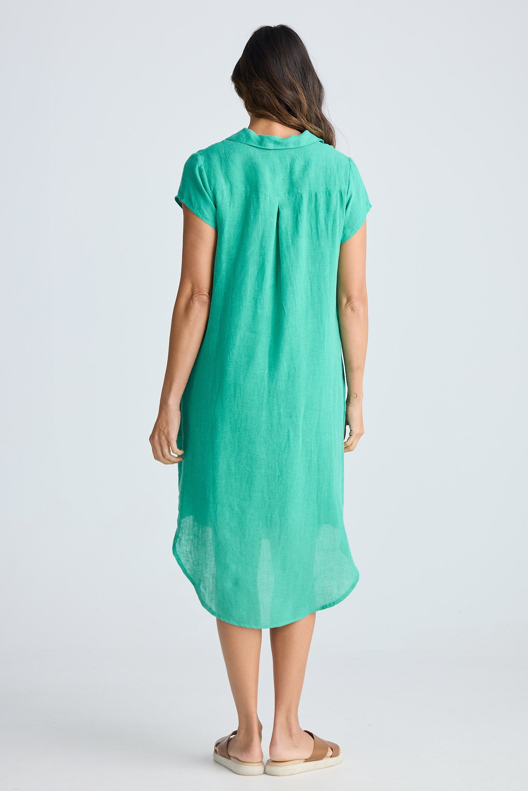 Woman wearing a green dress on a white background
