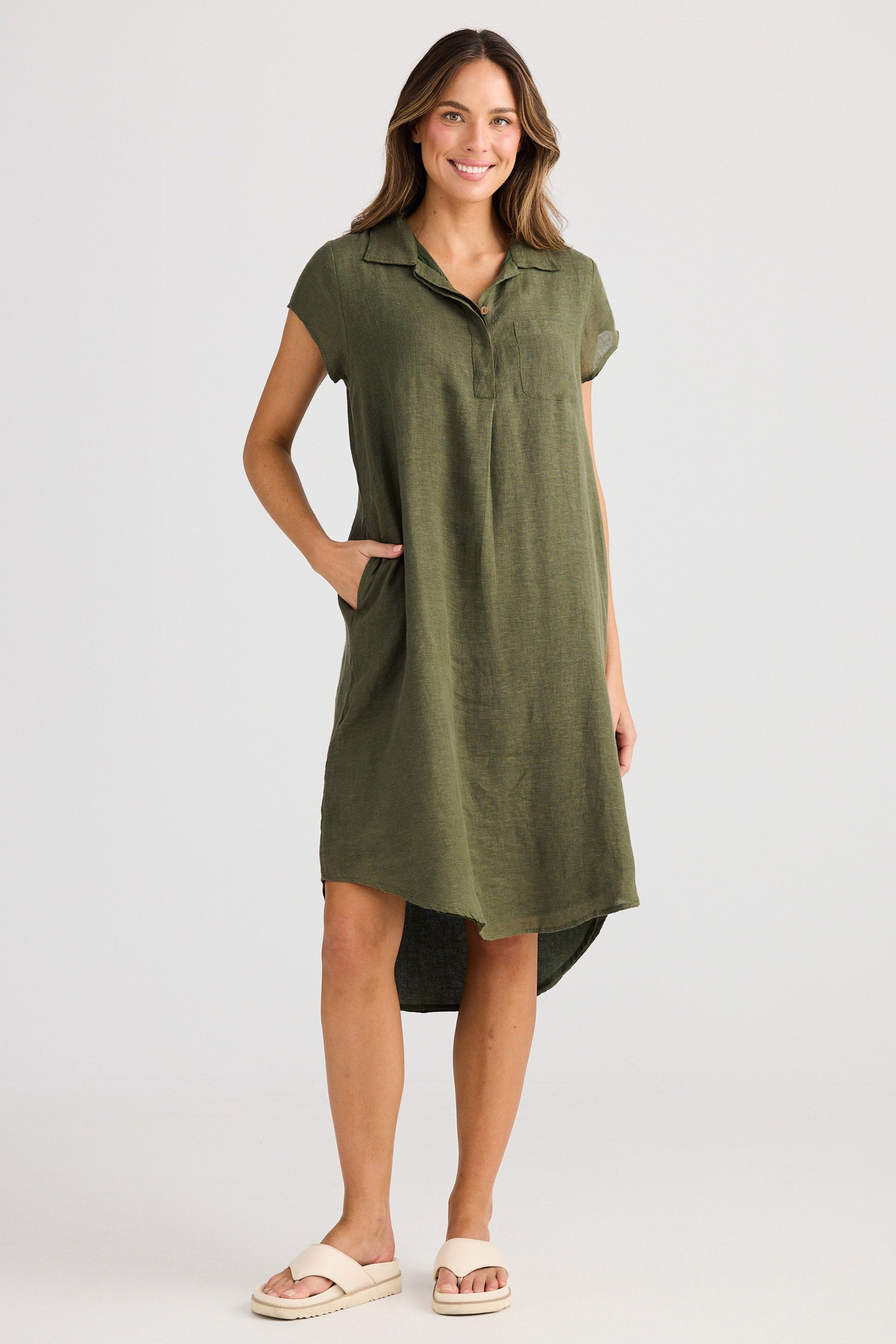 Woman wearing a green dress with a white background