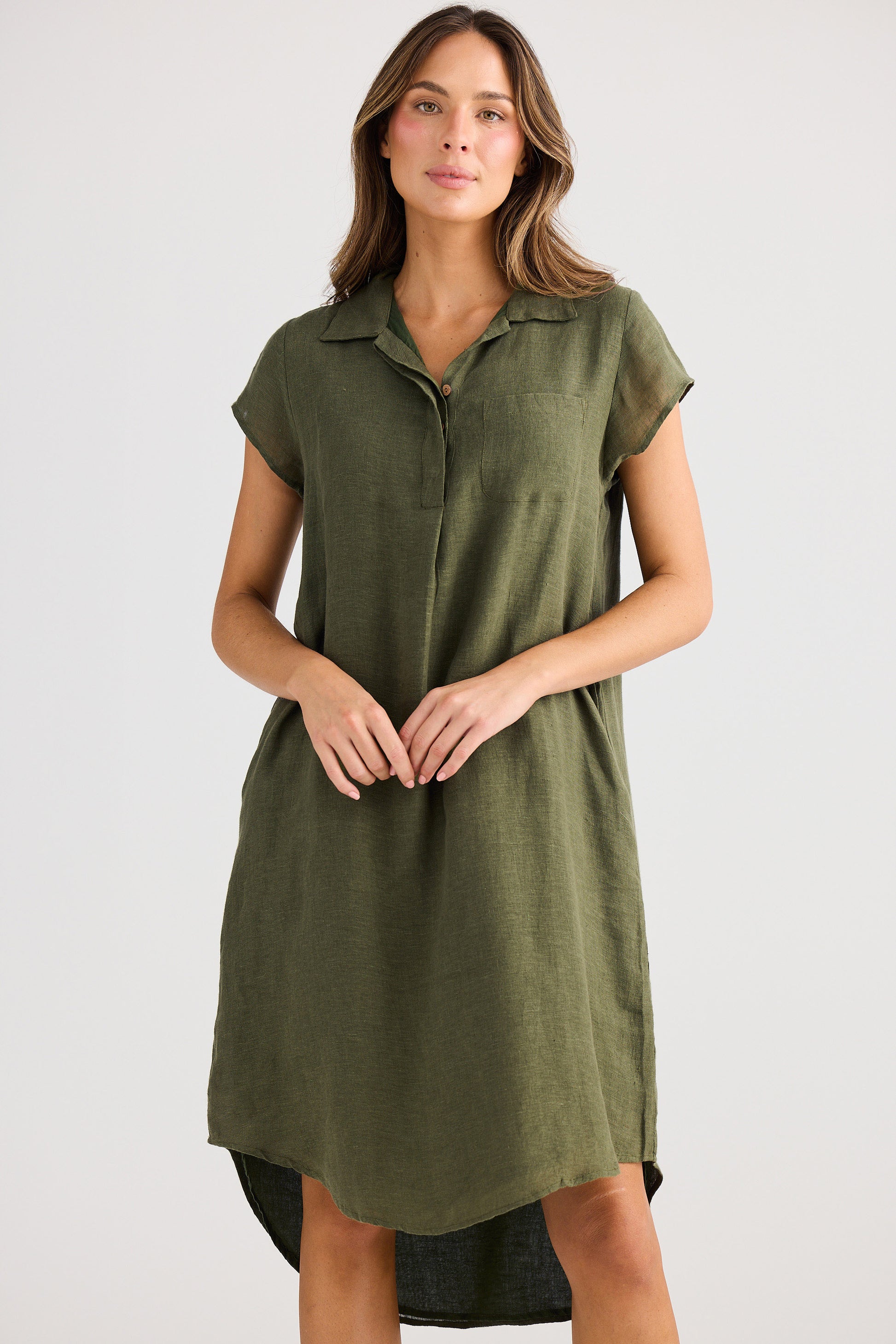Woman wearing an olive green dress on a white background