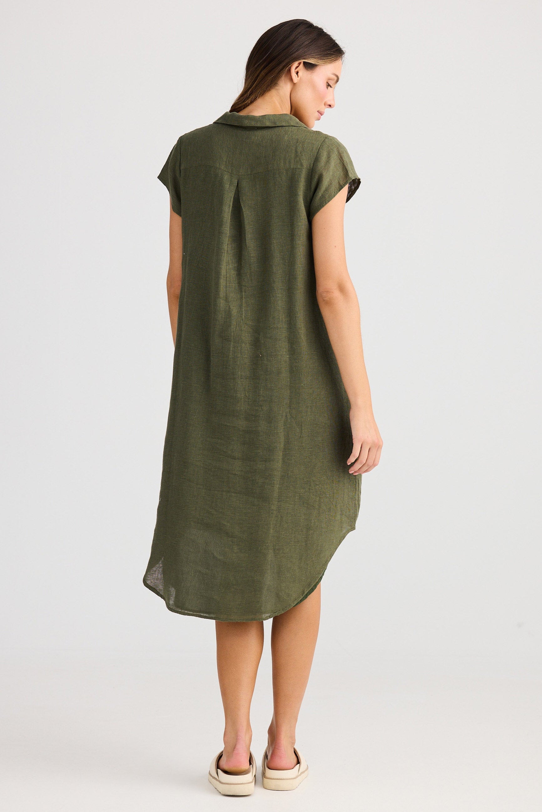 Woman wearing a green dress on a white background