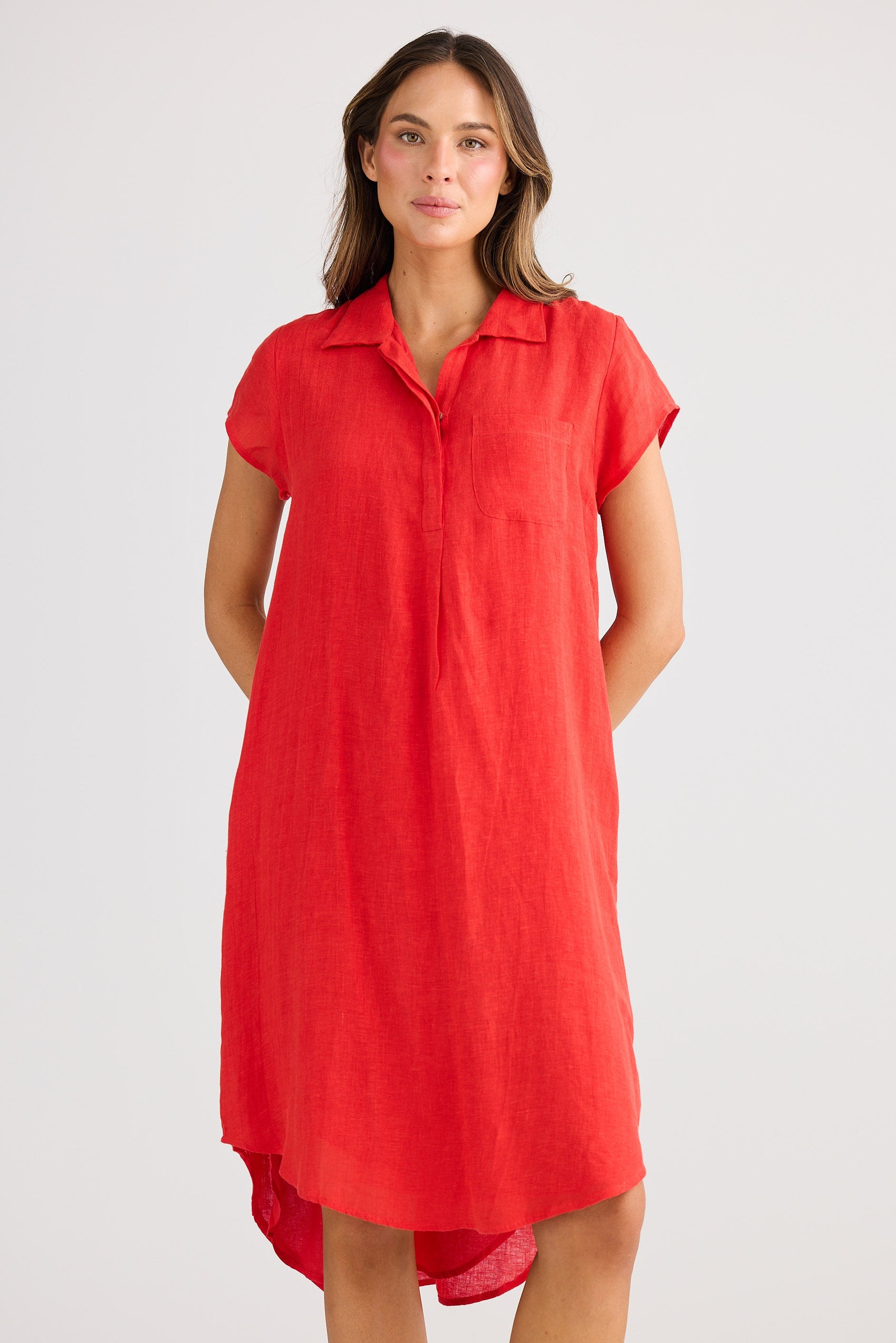 Woman wearing a red dress against a white background