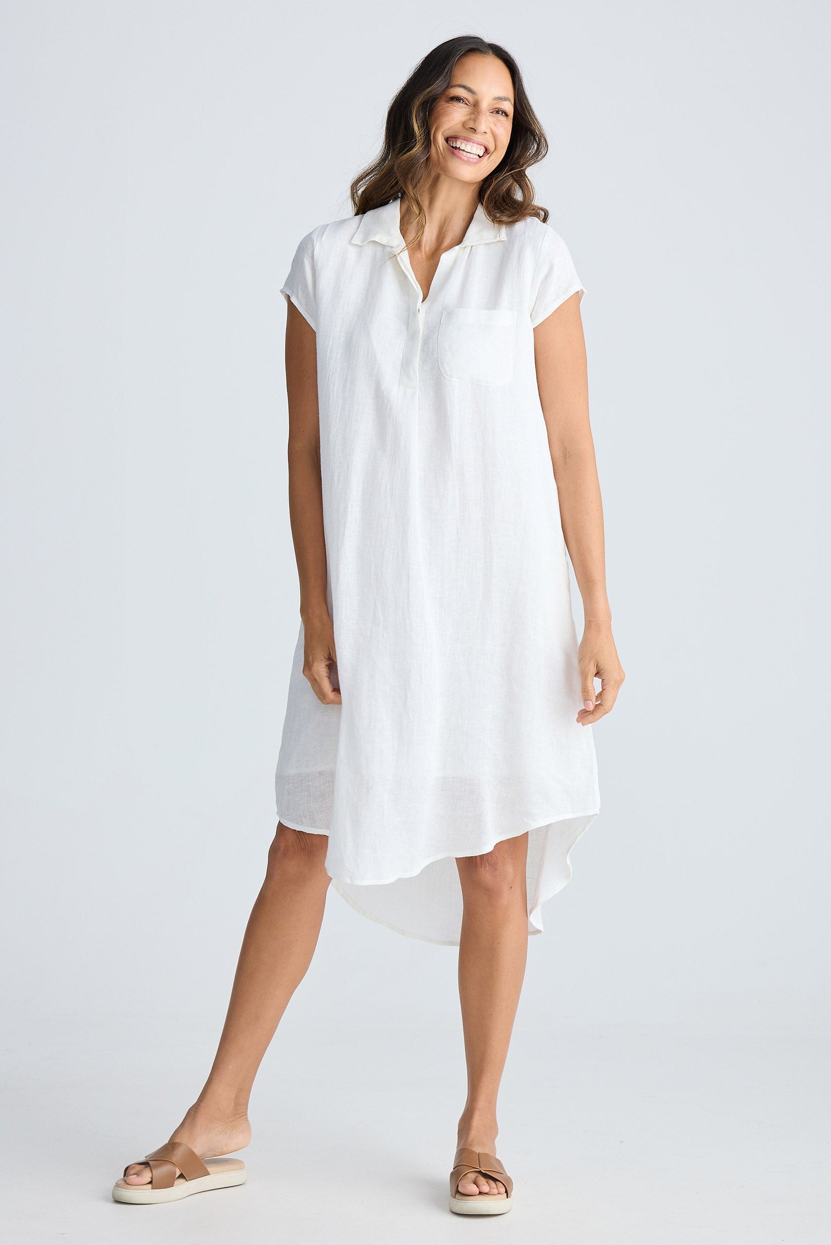 Woman wearing a white dress on a plain background