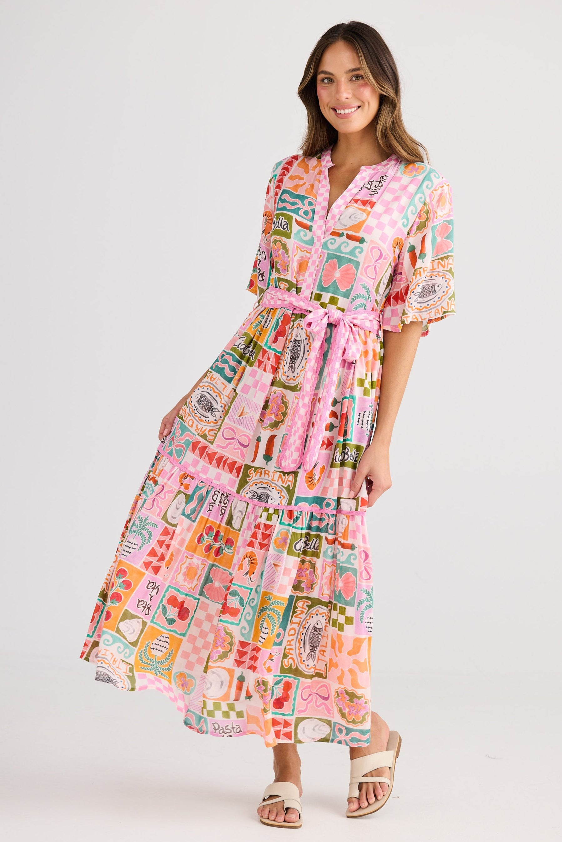Woman wearing a colorful patterned dress on a white background