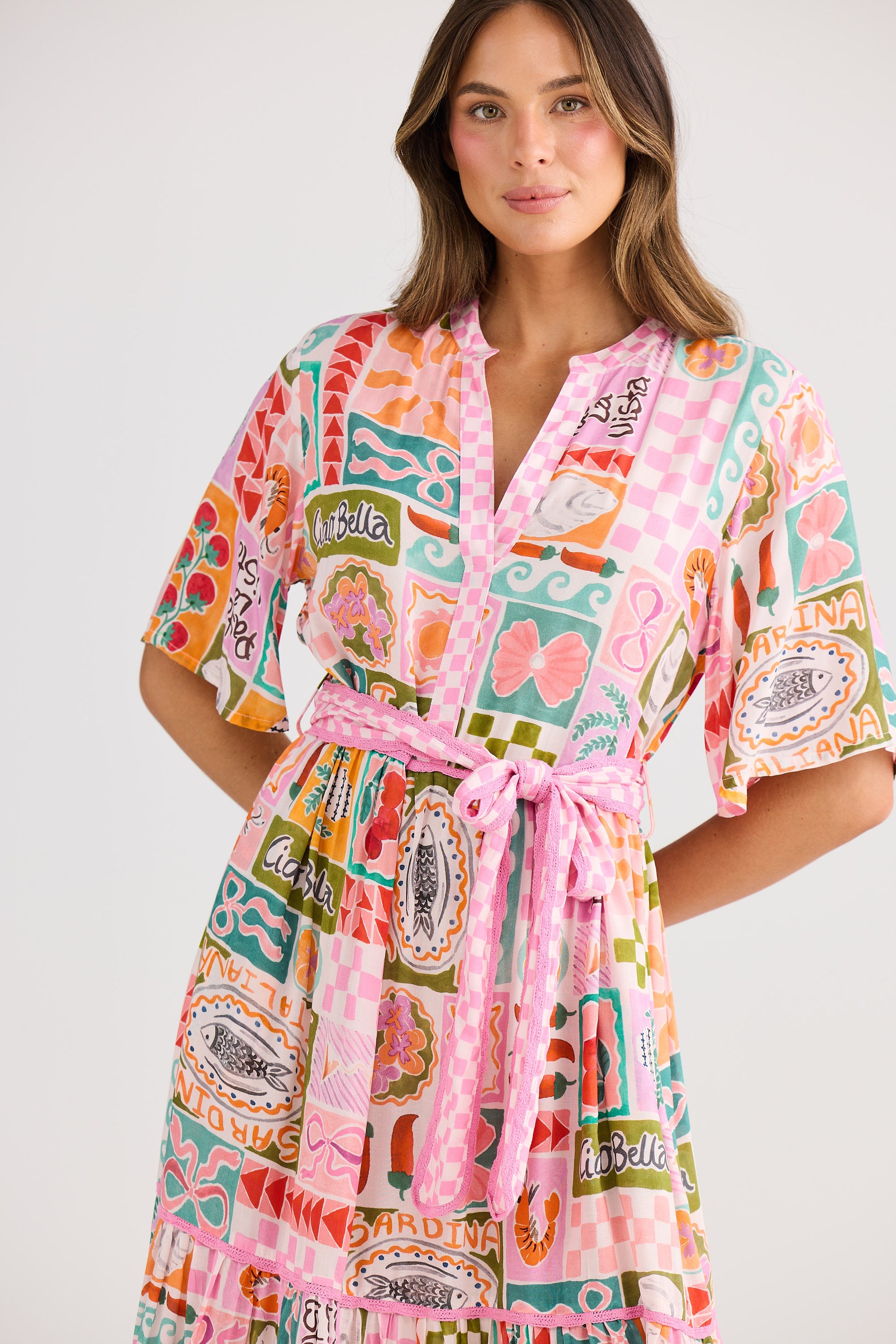 Woman wearing a colorful patterned robe on a white background