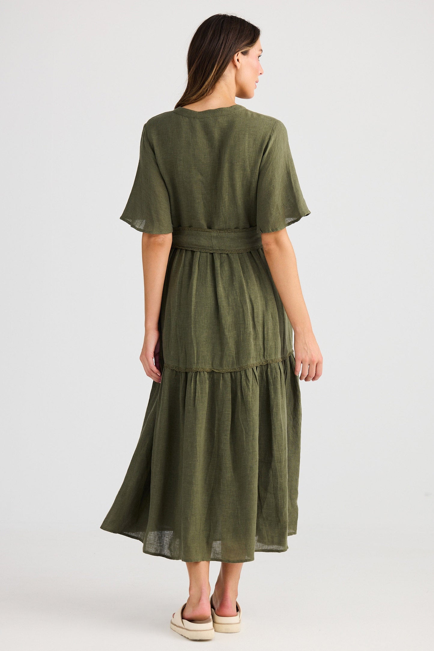 Woman wearing a green dress on a white background